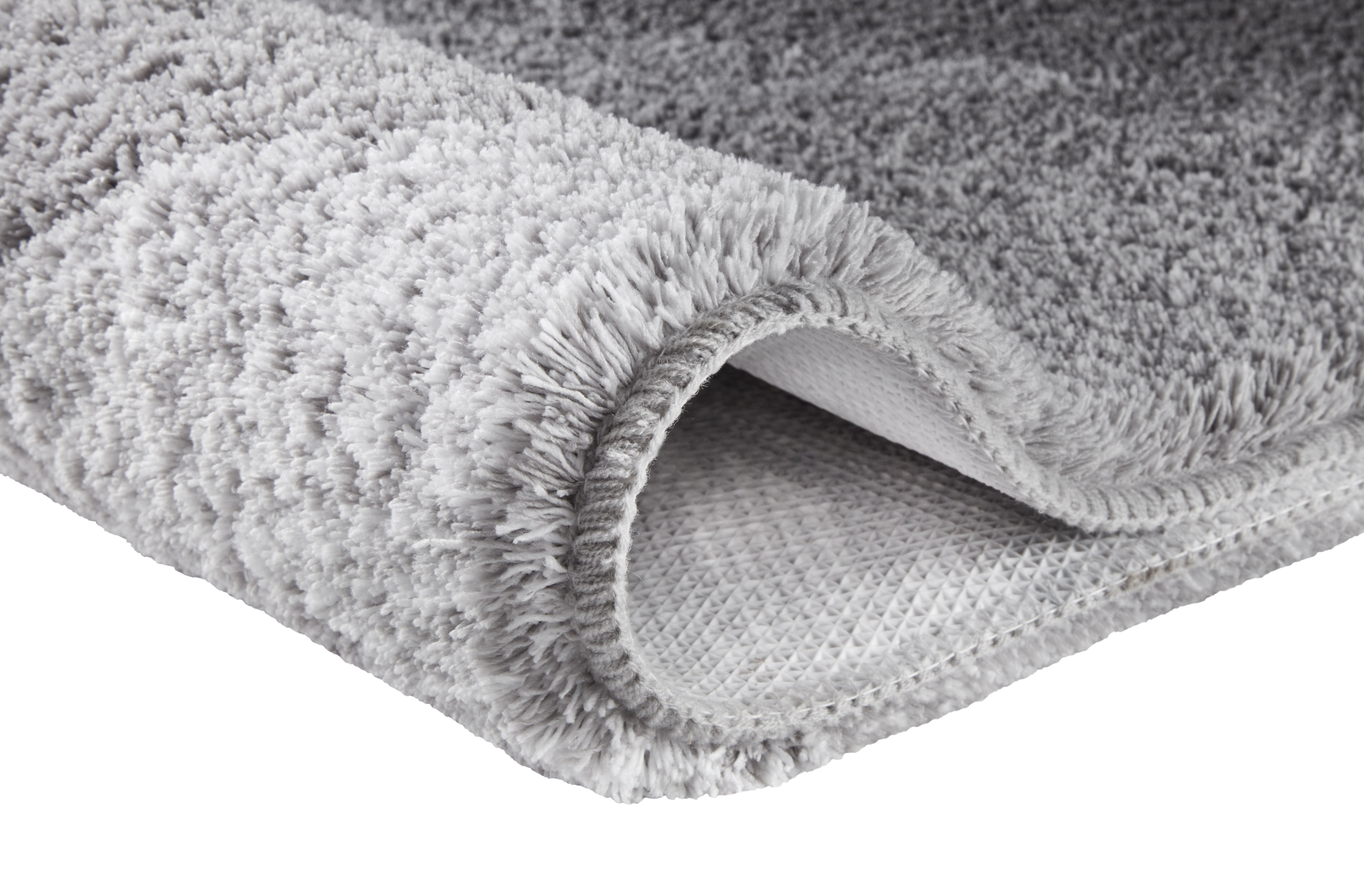 Grauer Hochflor-Teppich mit rutschhemmender Unterseite.