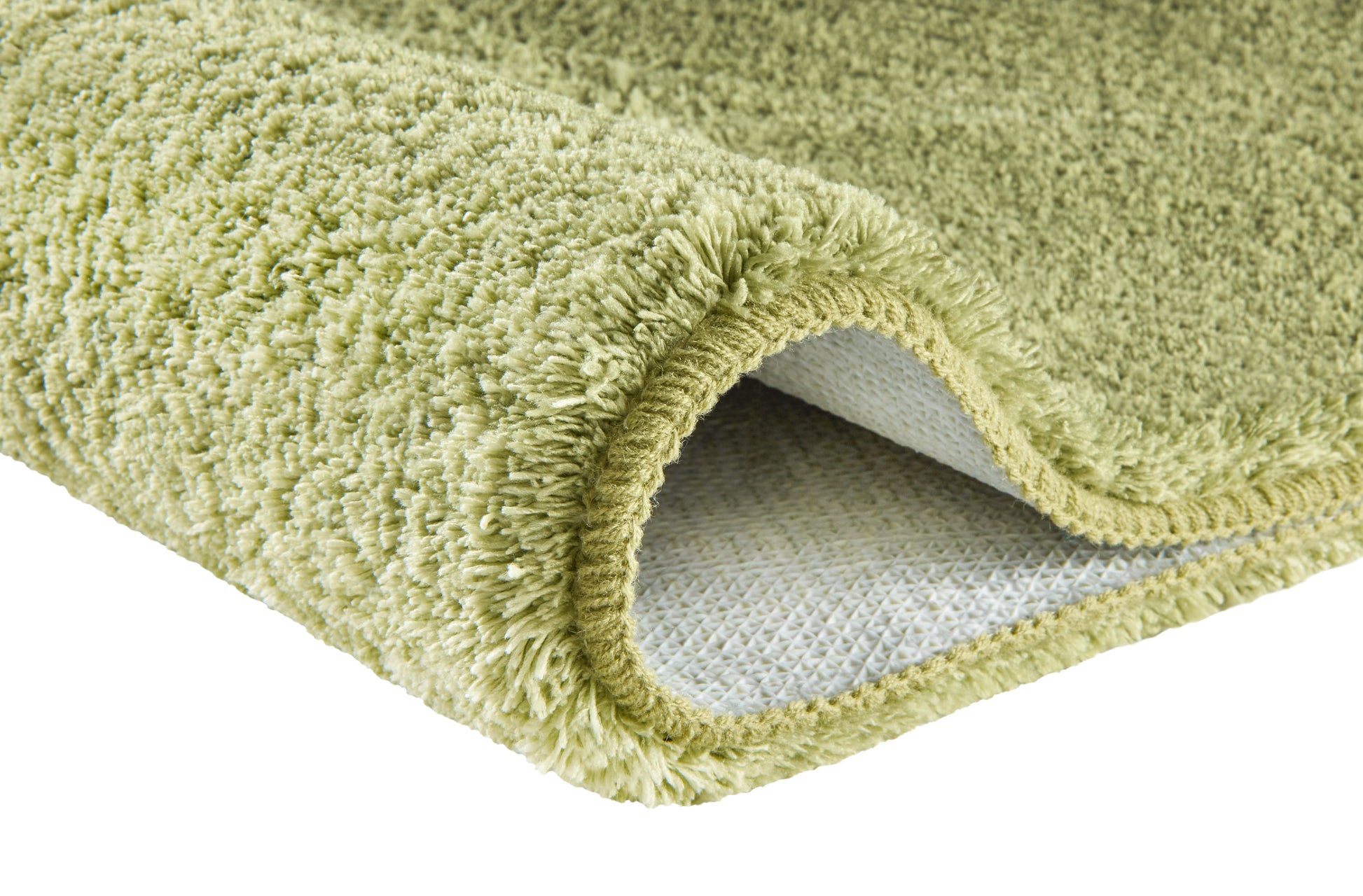 Hellgrüner Hochflor-Badteppich mit rutschfester Unterseite.