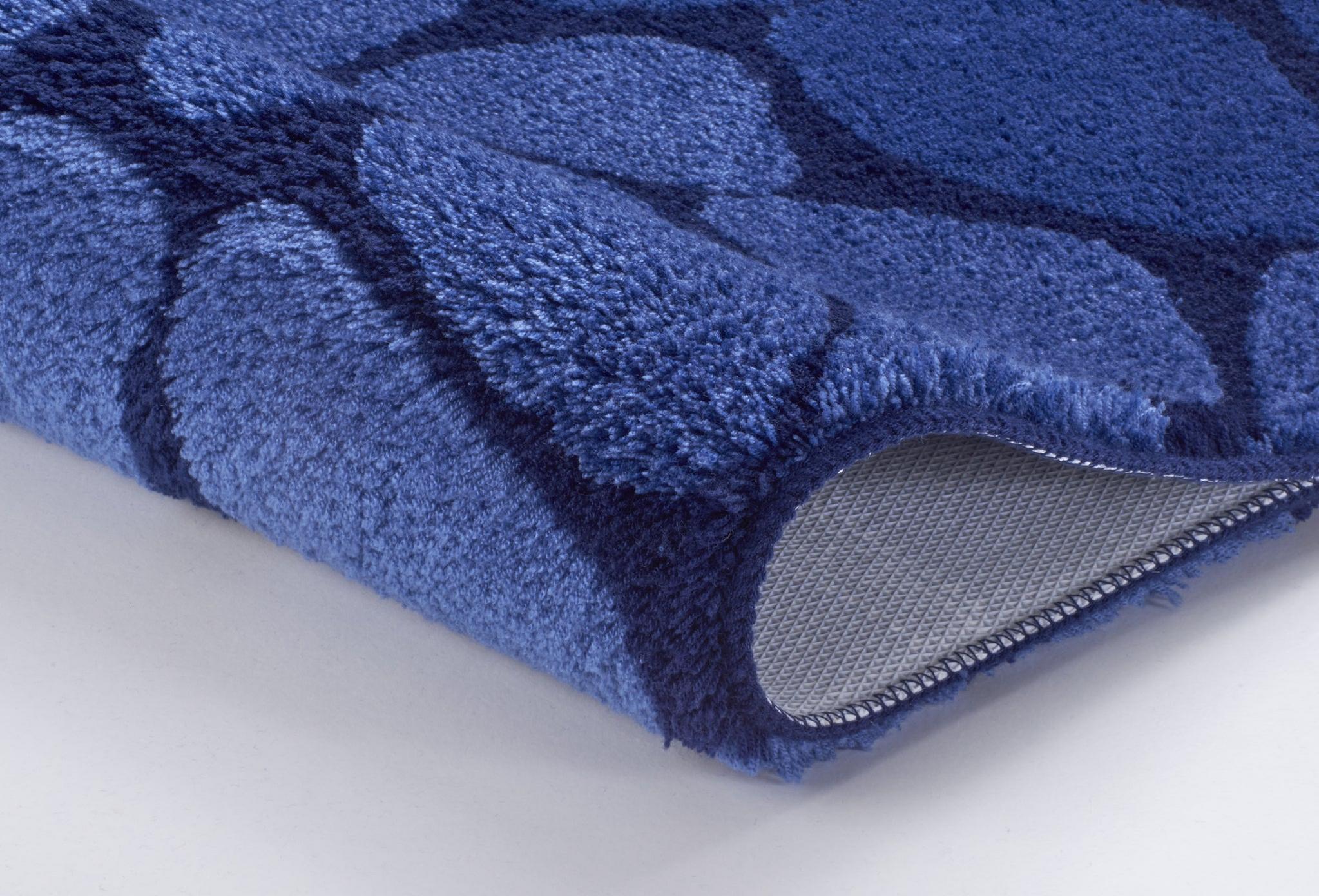 Nahaufnahme einer blauen Badematte mit Muster und rutschfester Rückseite