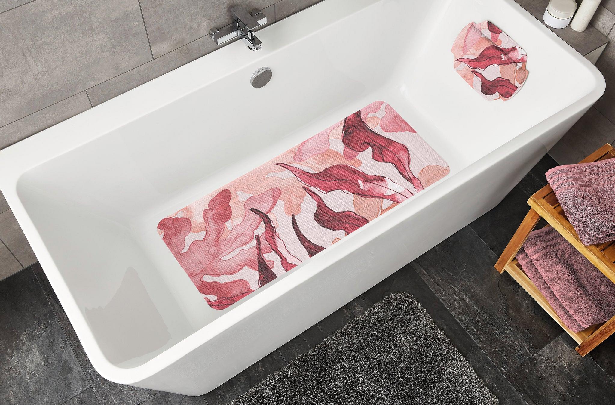 Weiße Badewanne mit rosa rutschfester Badematte und passender Kopflage