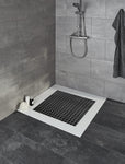 Bodengleiche Dusche mit grauen Fliesen und quadratischer Duschmatte
