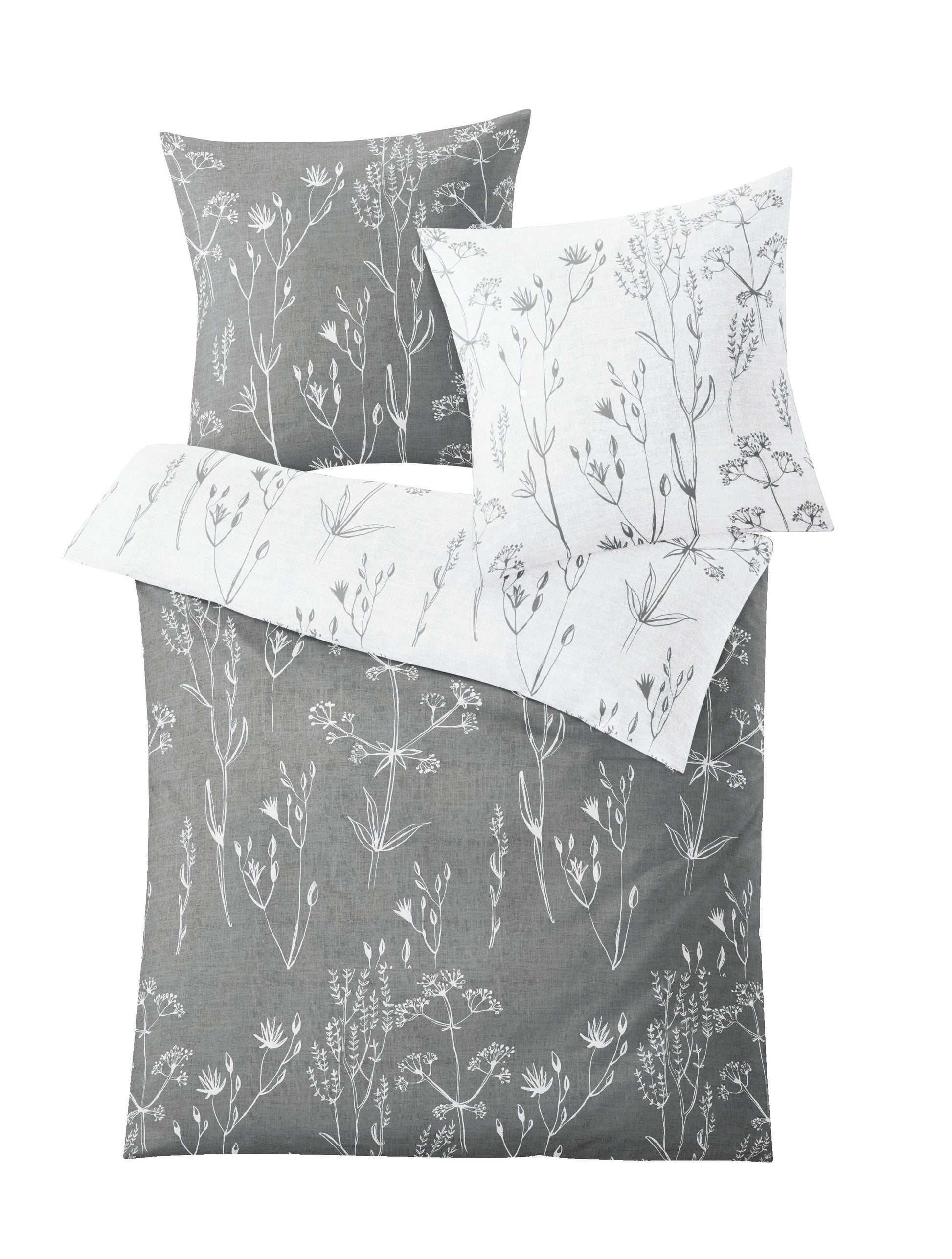 Bettwäsche Satin SAVANNAH Grau 135x200 und 80x80 mit weißem floralen Wendedesign ist abgebildet.