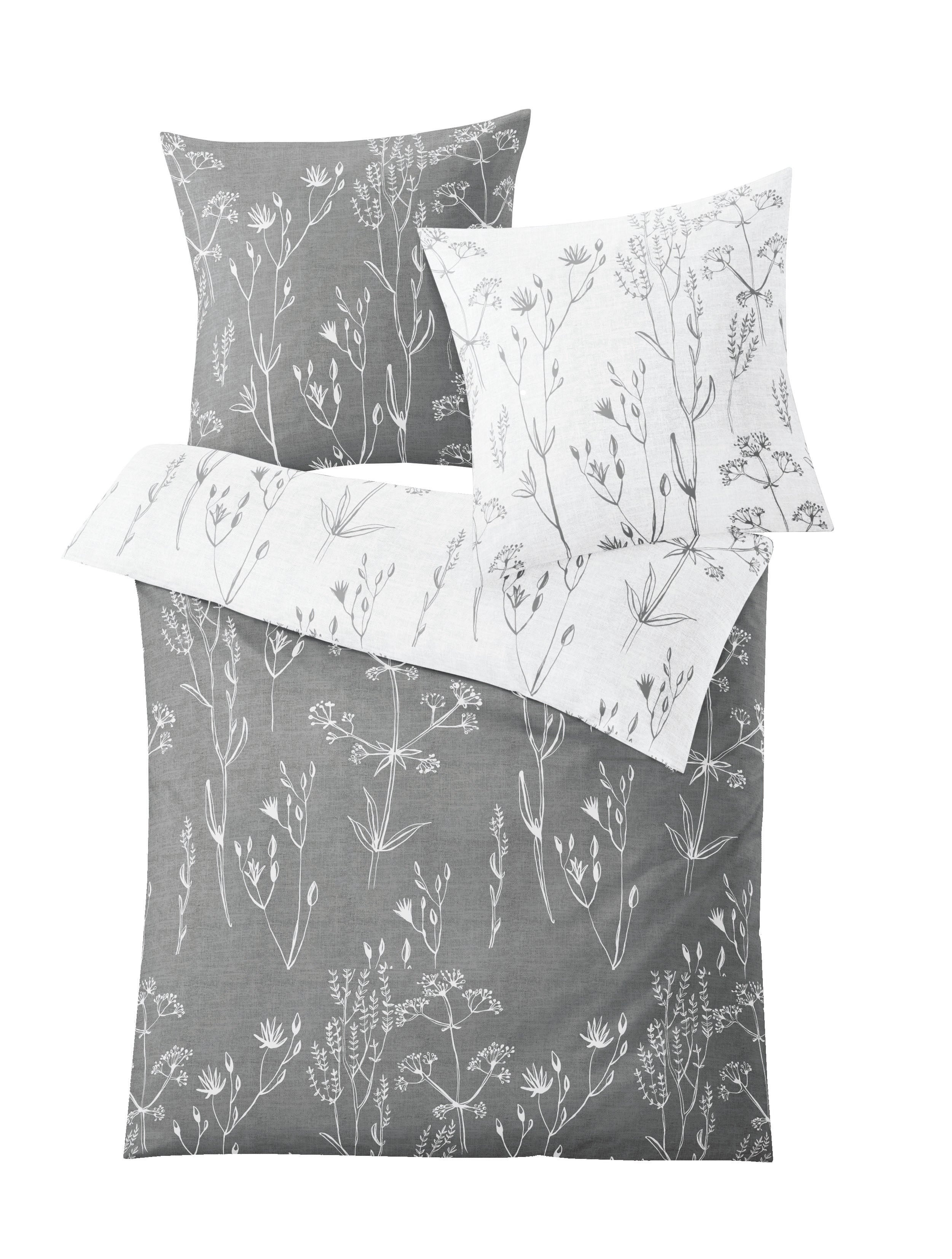 Bettwäsche Satin SAVANNAH Grau 135x200 und 80x80 mit weißem floralen Wendedesign ist abgebildet.