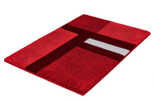Roter Badteppich mit geometrischem Muster in Rot und Weiß.