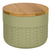 Die Wattedose DASH Dill mit Bambusdeckel steht als runde, grün strukturierte Dose im Fokus.