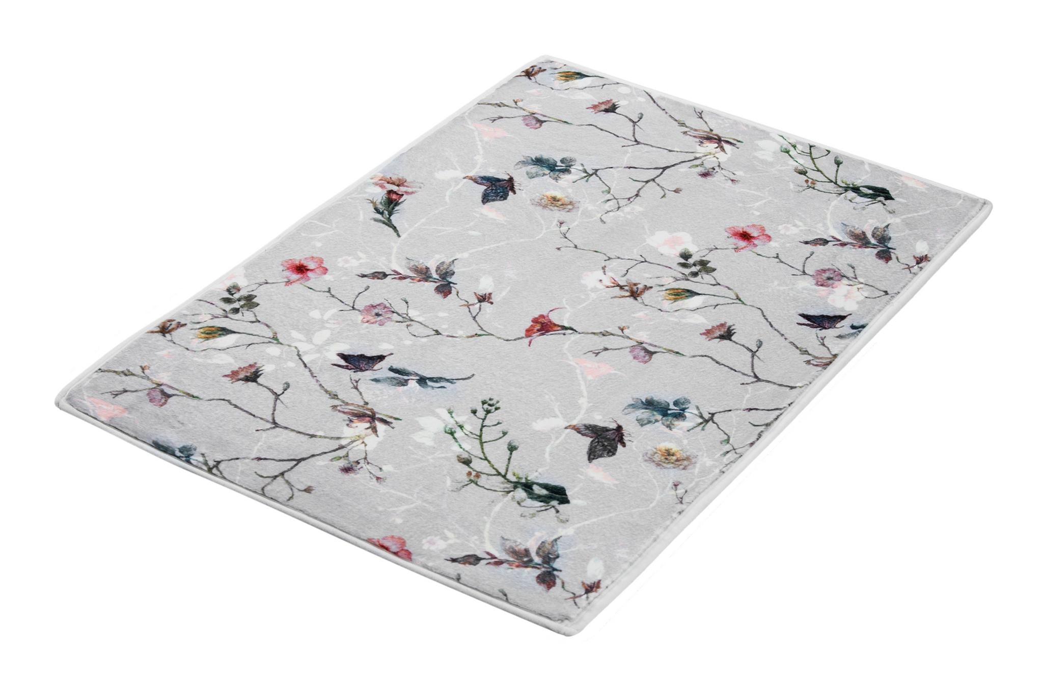 Graue Badematte mit zartem Blumen- und Zweigmotiv in Pastellfarben