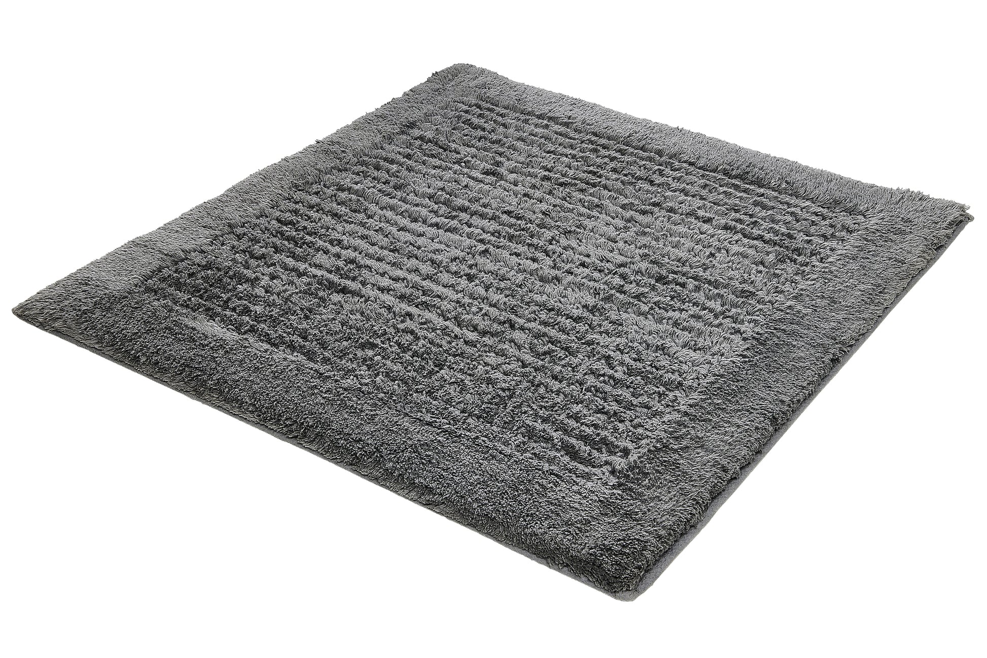 Badteppich NET Schiefer 60 x 60 cm liegt als grauer, flauschiger Teppich auf einem neutralen Untergrund.