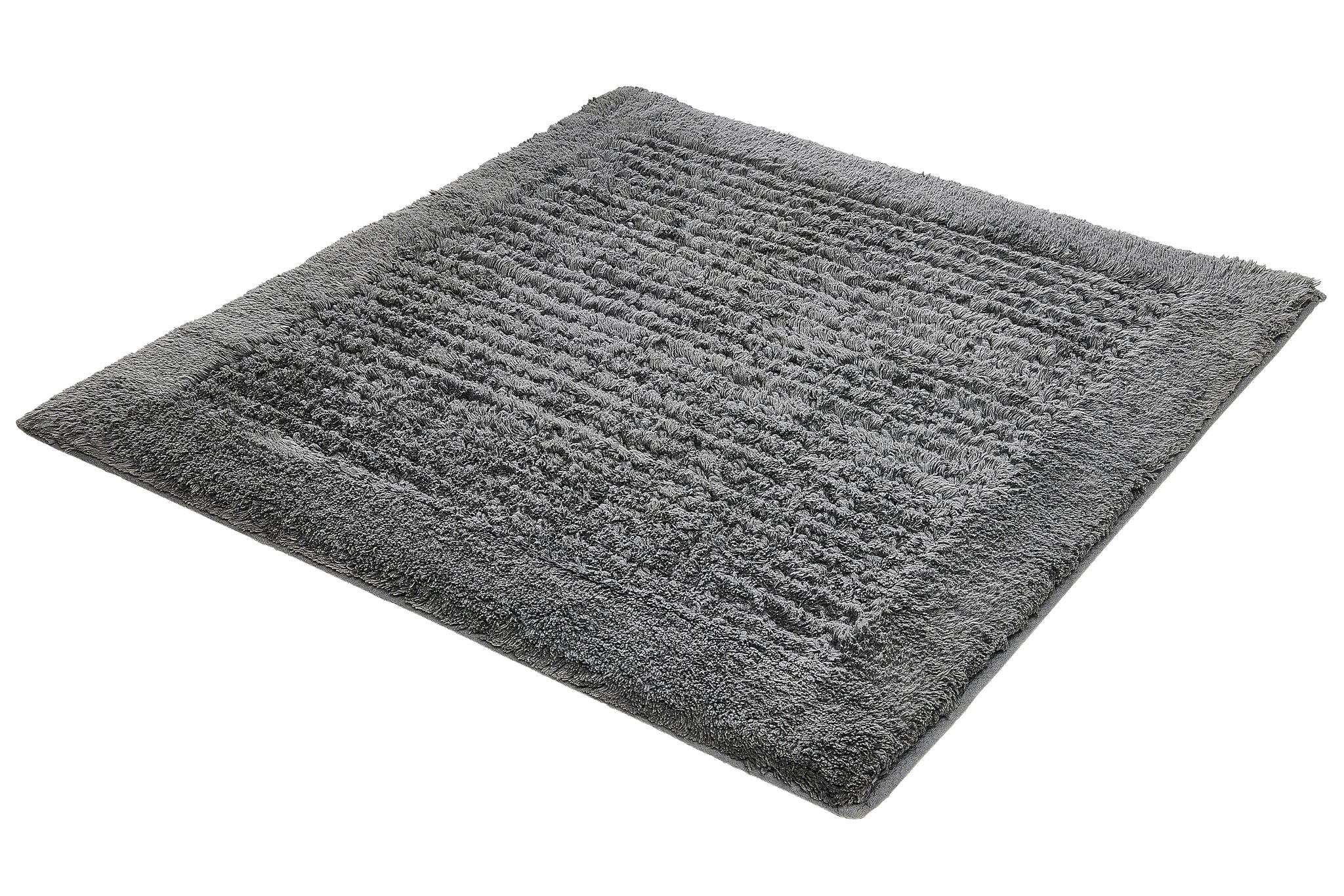 Badteppich NET Schiefer 60 x 60 cm liegt als grauer, flauschiger Teppich auf einem neutralen Untergrund.