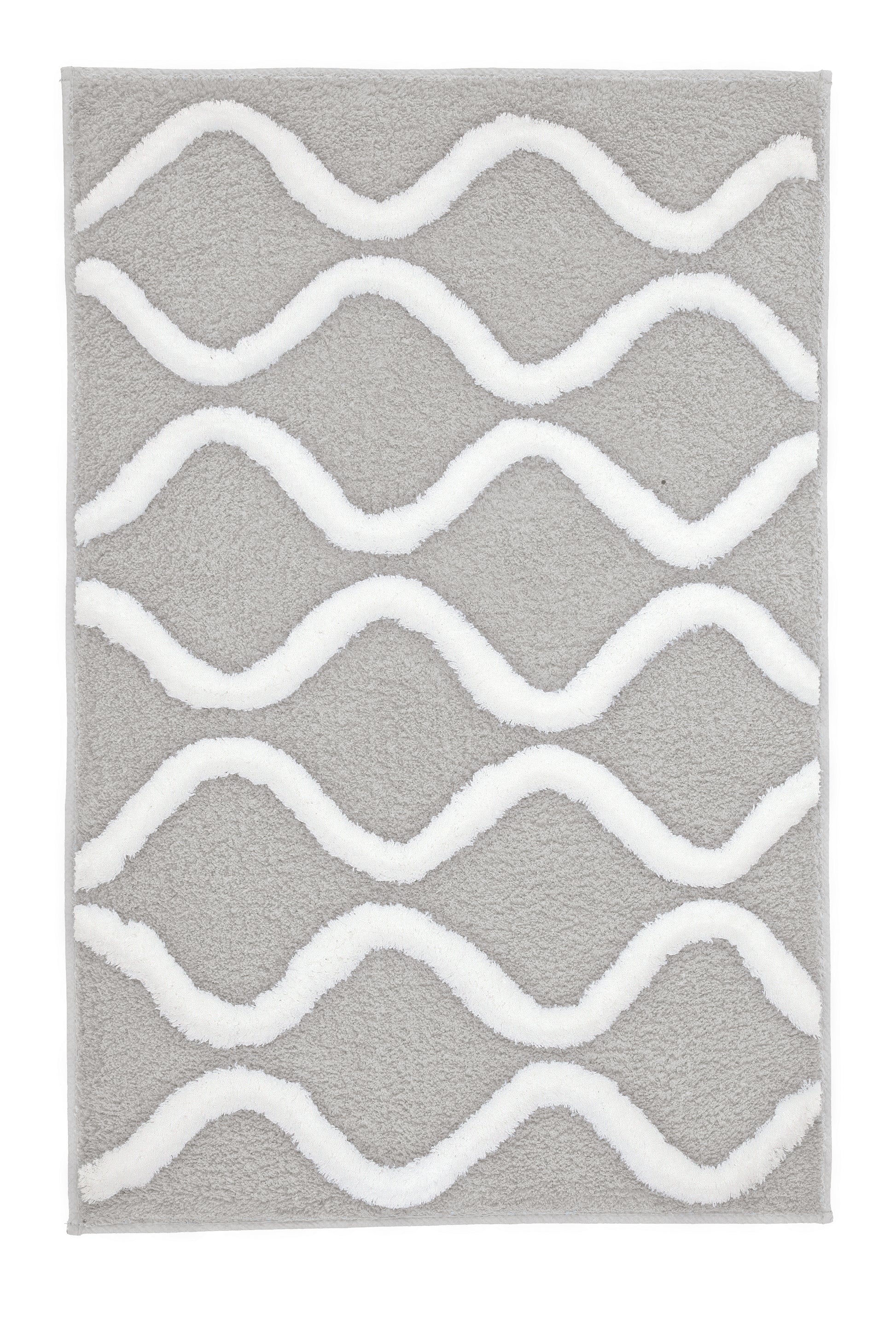 Der Badteppich PIANA Auster 70 x 120 cm liegt mit weißem Wellenmuster auf grauem Grund.