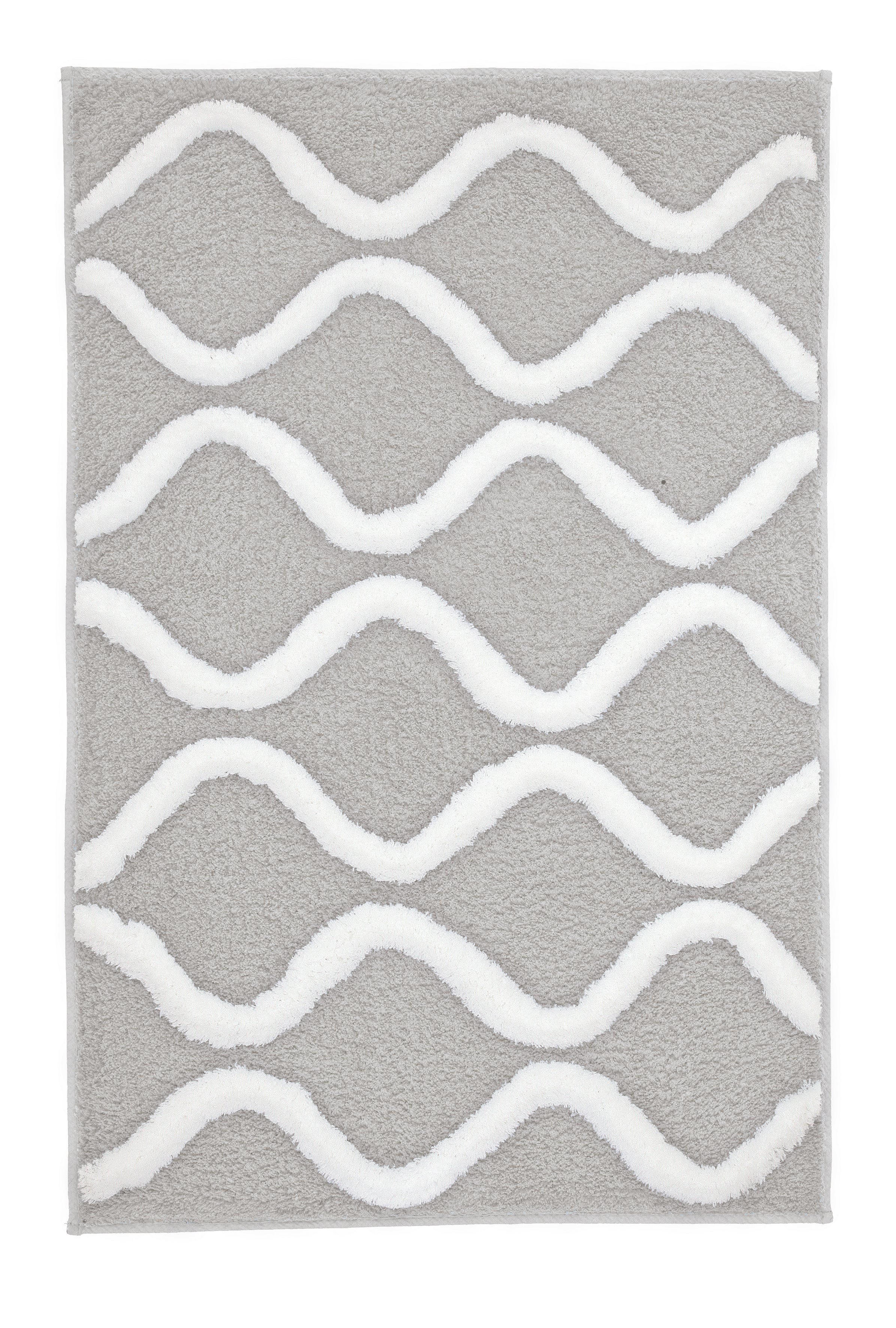 Der Badteppich PIANA Auster 70 x 120 cm liegt mit weißem Wellenmuster auf grauem Grund.