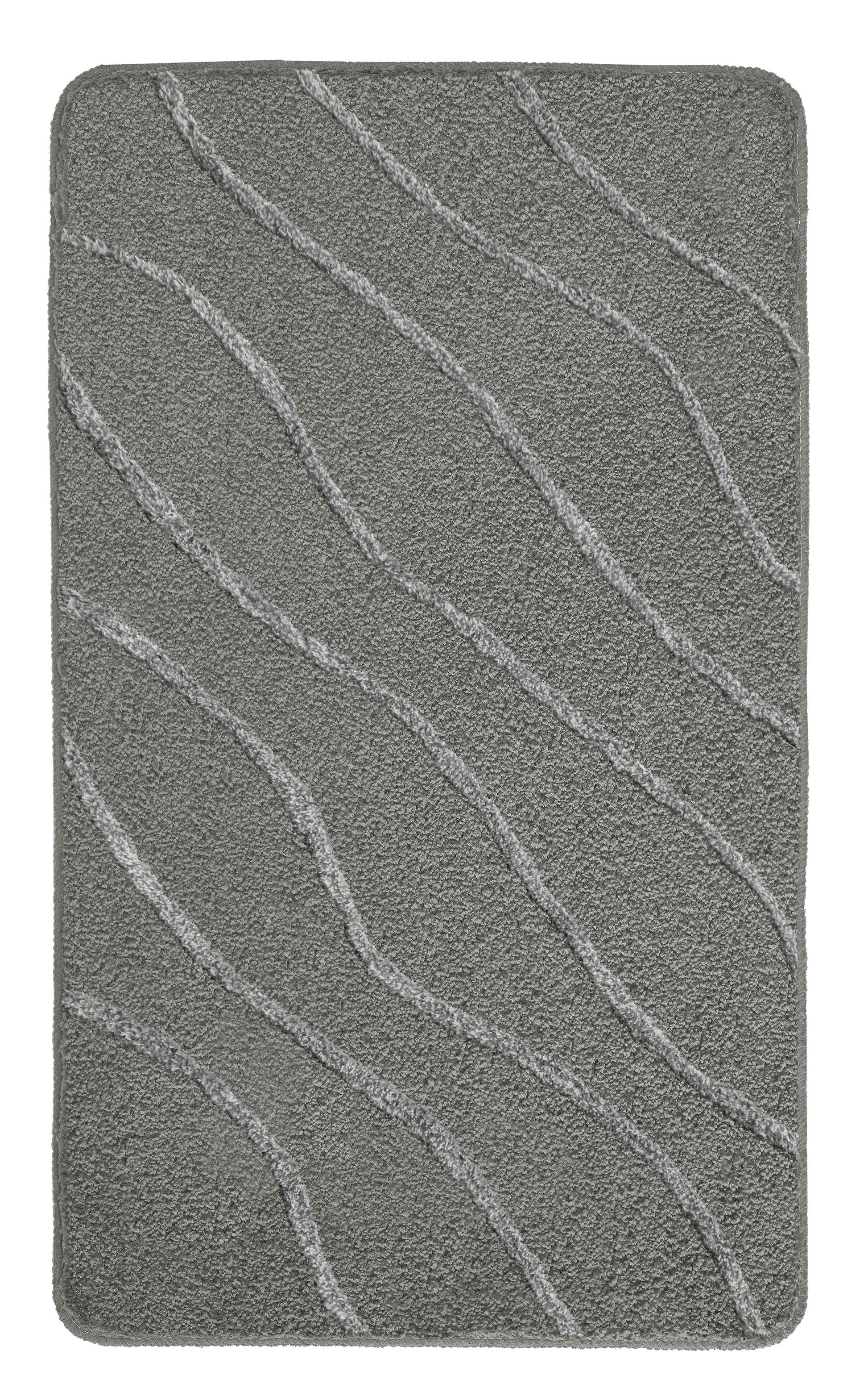 Badteppich TRAM Anthrazit 70 x 120 cm liegt rechteckig mit Wellenmuster auf hellem Hintergrund.