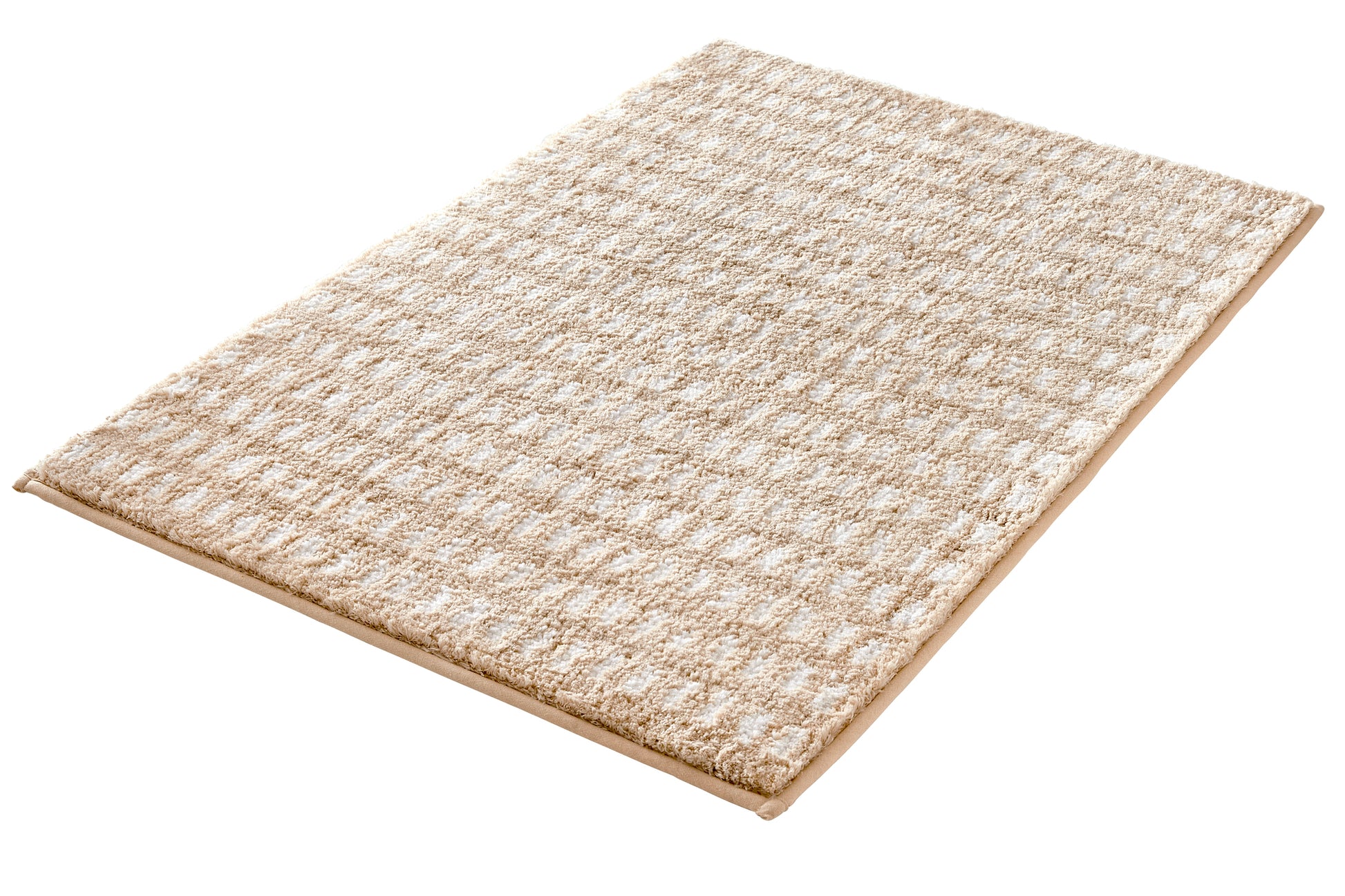 Badteppich DOTTINO Macadamia 70 x 120 cm liegt flach auf hellem Untergrund.