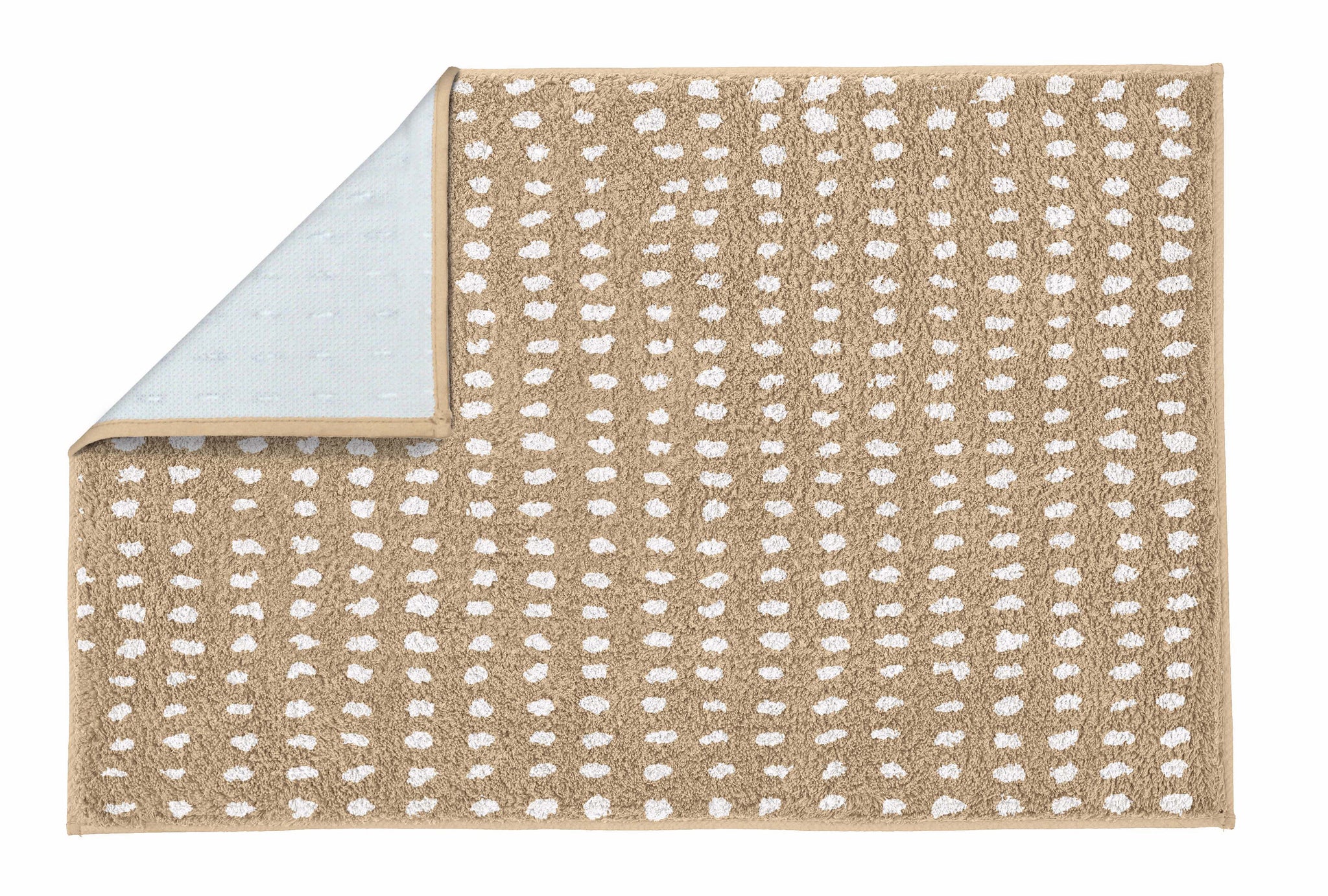 Badteppich DOTTINO Macadamia 60x90 cm mit weißen Punkten und umgeschlagener Ecke ist zu sehen.