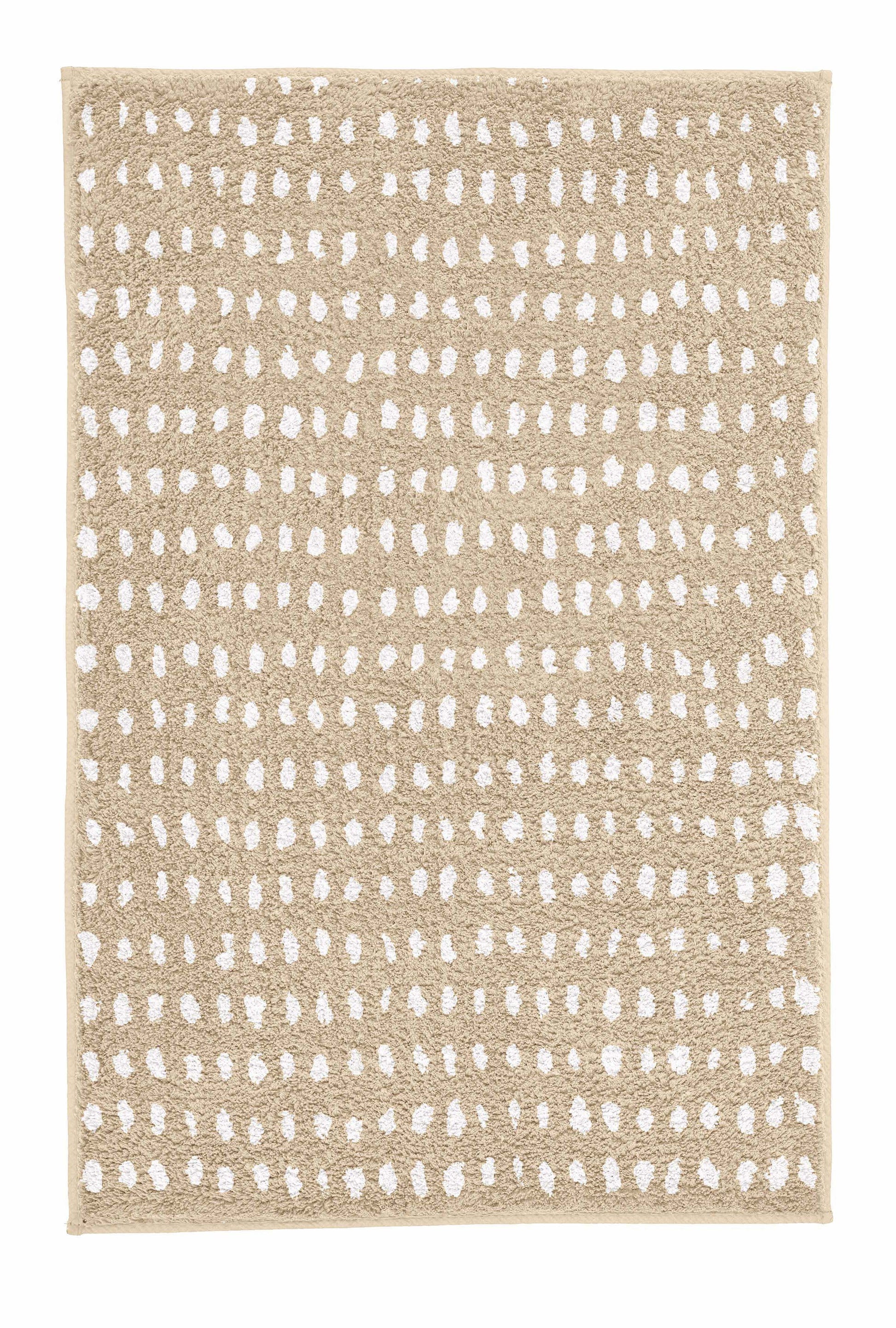 Badteppich DOTTINO Macadamia 60 x 90 cm mit weißem Punktmuster in Draufsicht.