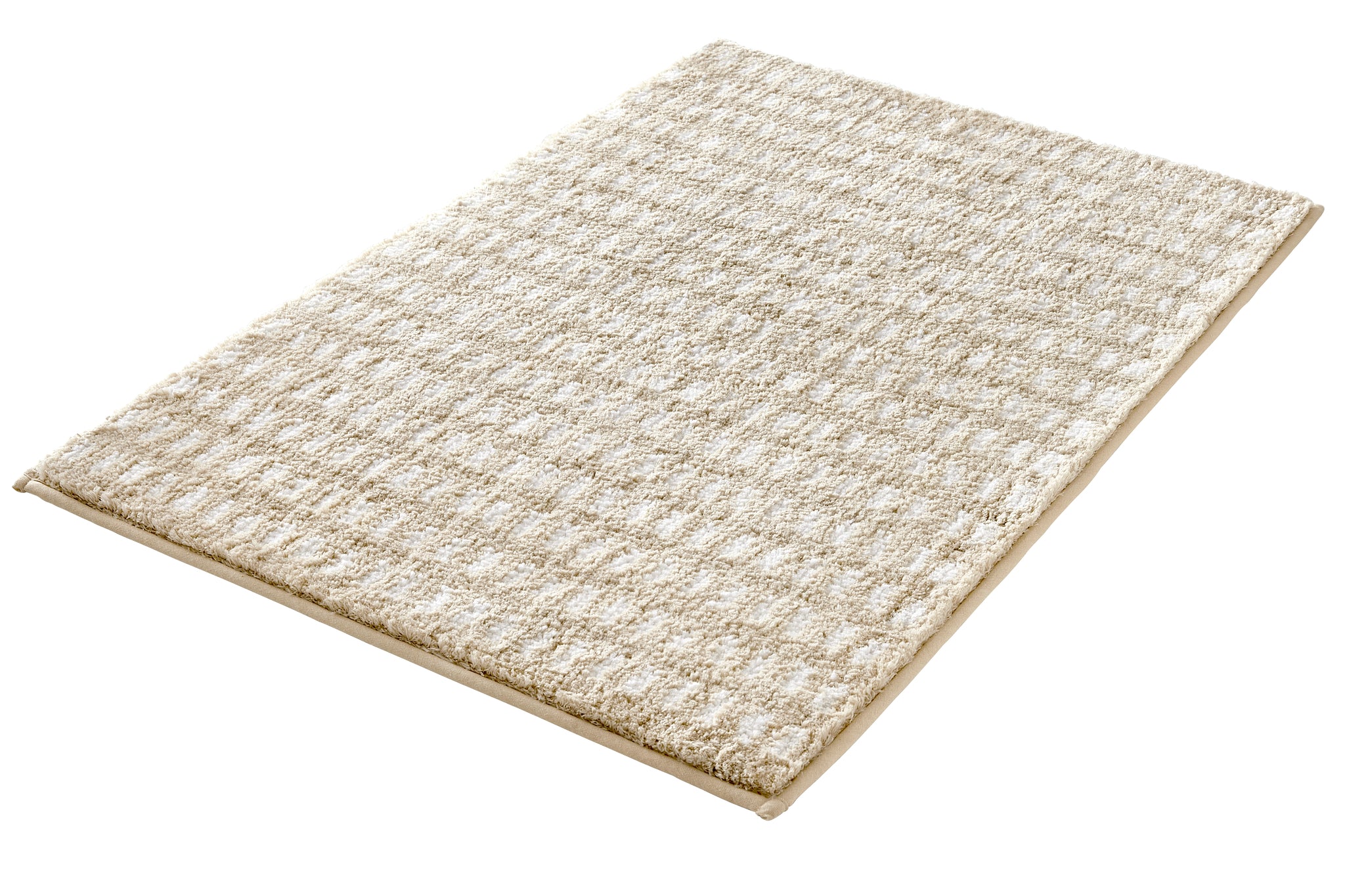 Der Badteppich DOTTINO Macadamia 60 x 90 cm liegt in Nahansicht auf einer hellen Fläche.