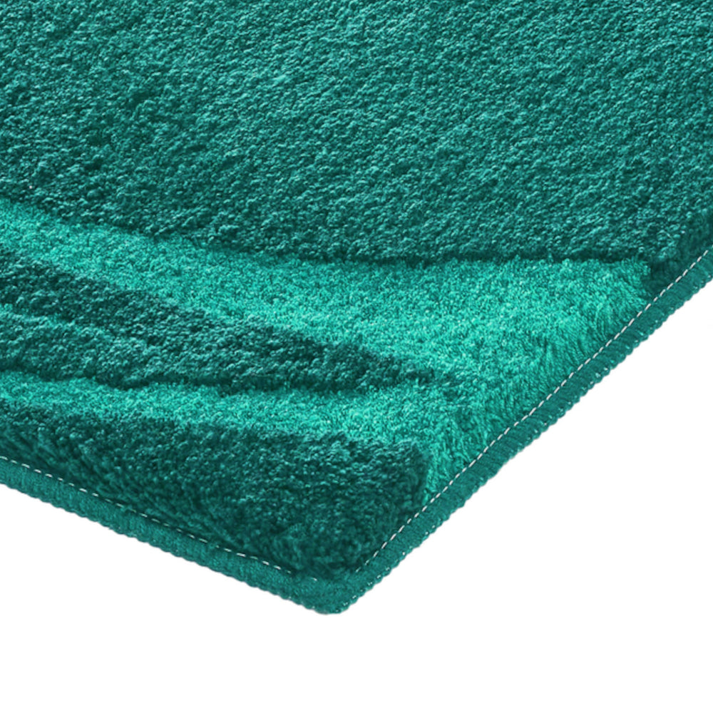 Naheaufnahme einer türkisgrünen Badematte mit weicher, dichter Oberfläche