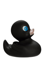 Schwarze Badeente mit blauen Augen im Profil vor weißem Hintergrund