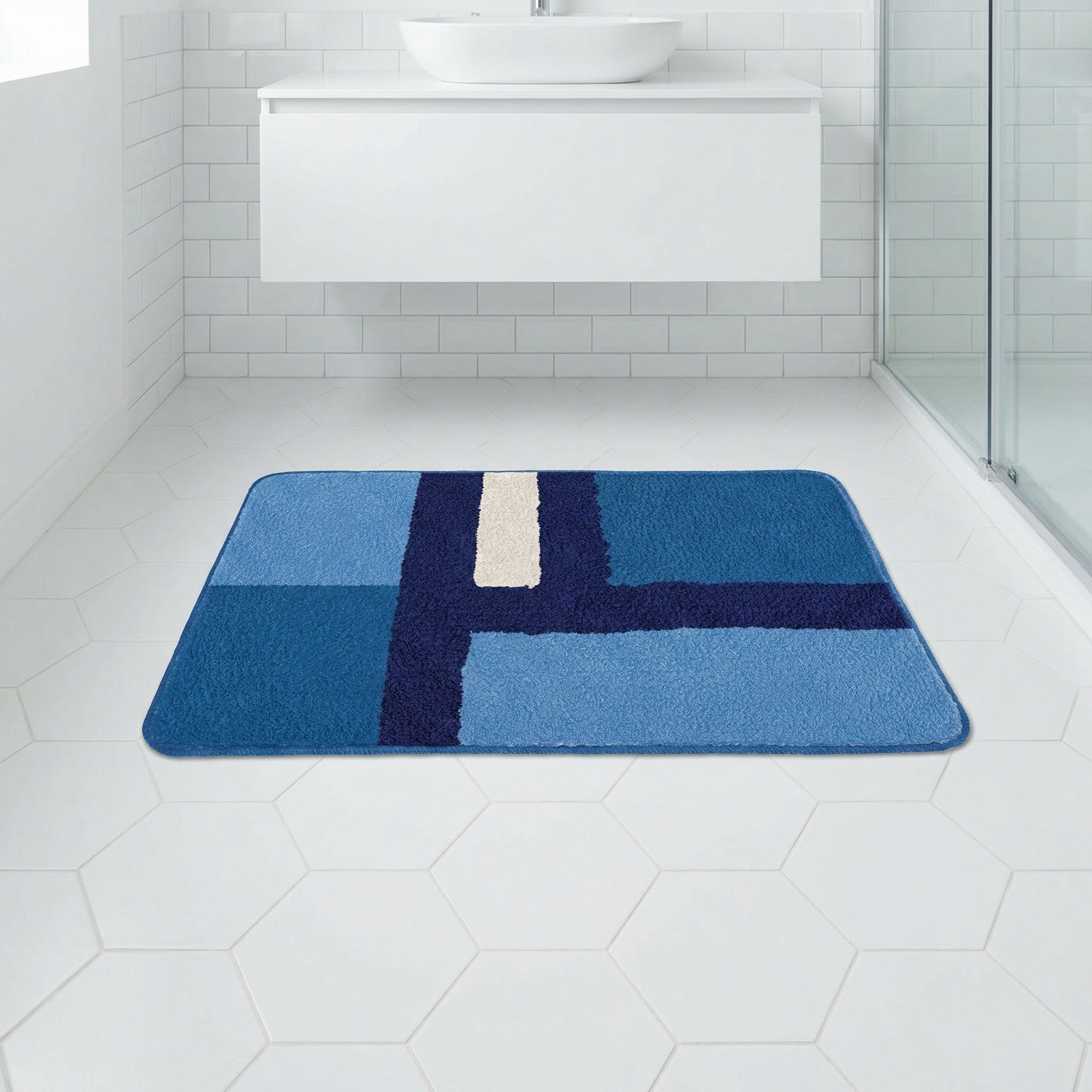 Blau gemusterte Badematte auf weißem Fliesenboden im modernen Bad