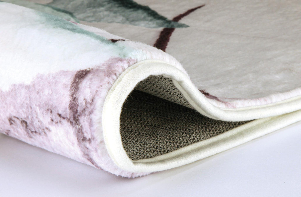 Gerollter, weicher Badteppich mit floralem Muster in Creme und Rosa.