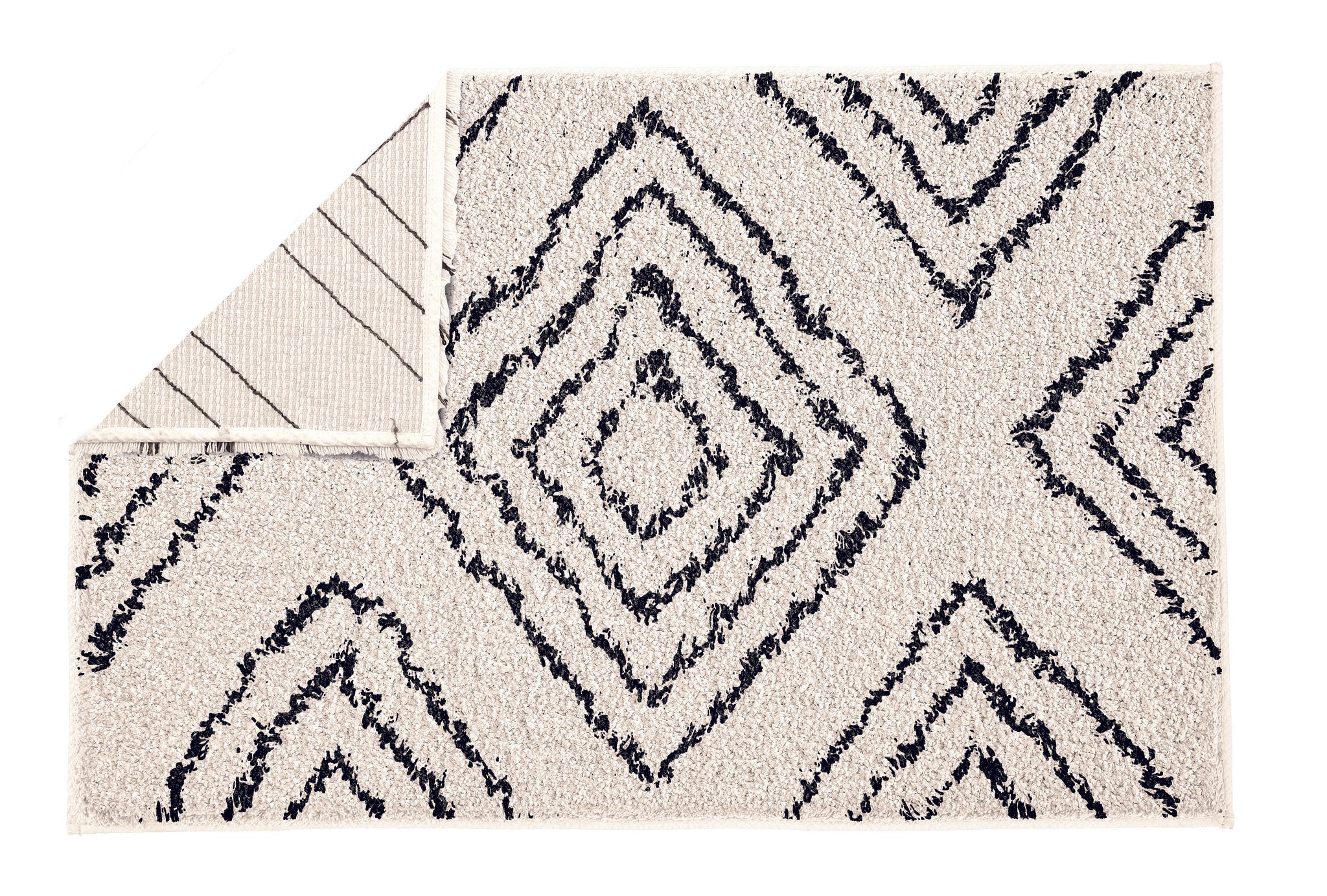 Beiger Badteppich mit schwarzen Rauten, Ecke zeigt die Rückseite