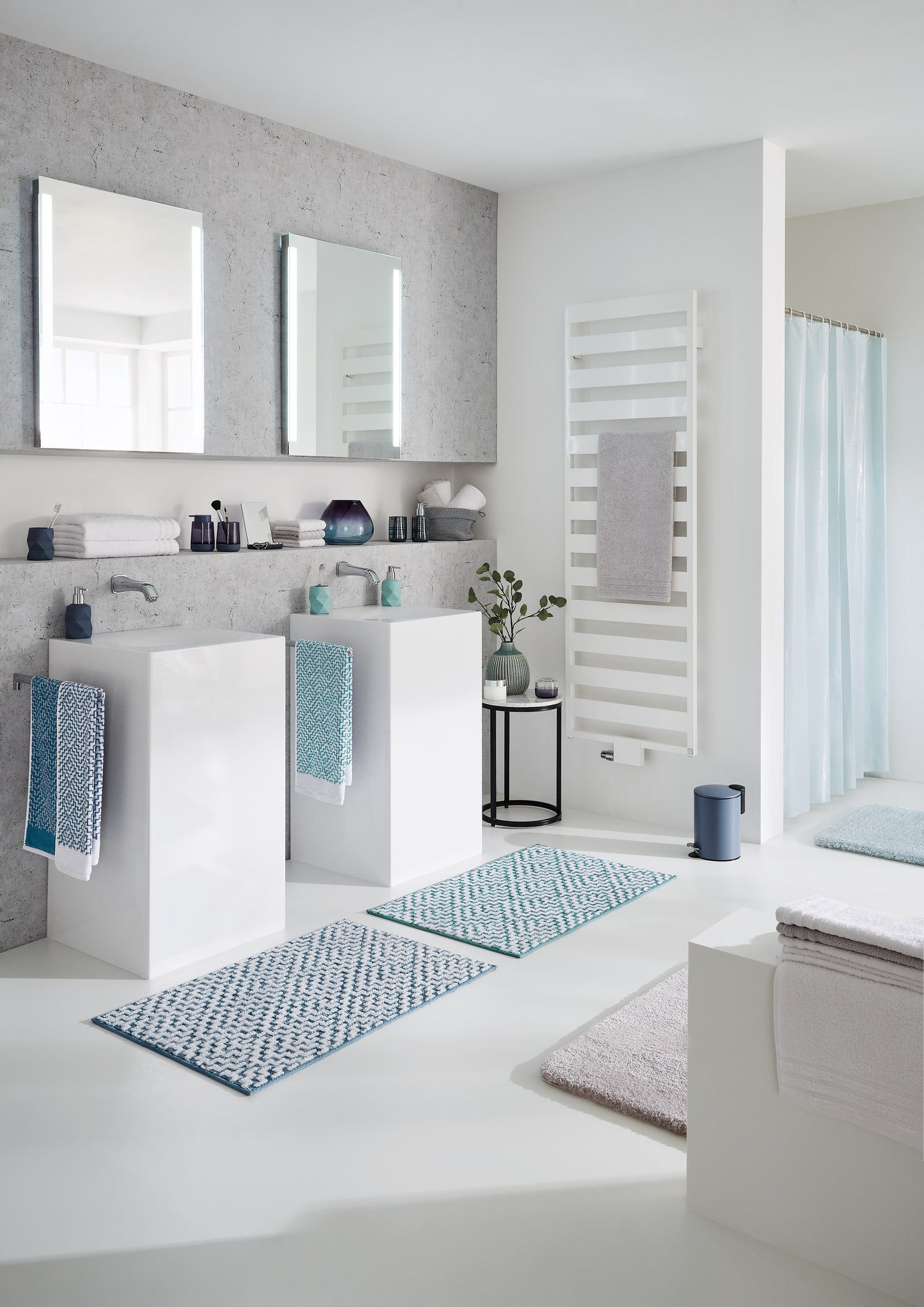 Modernes weißes Bad mit Doppelwaschbecken und blauen Textilien