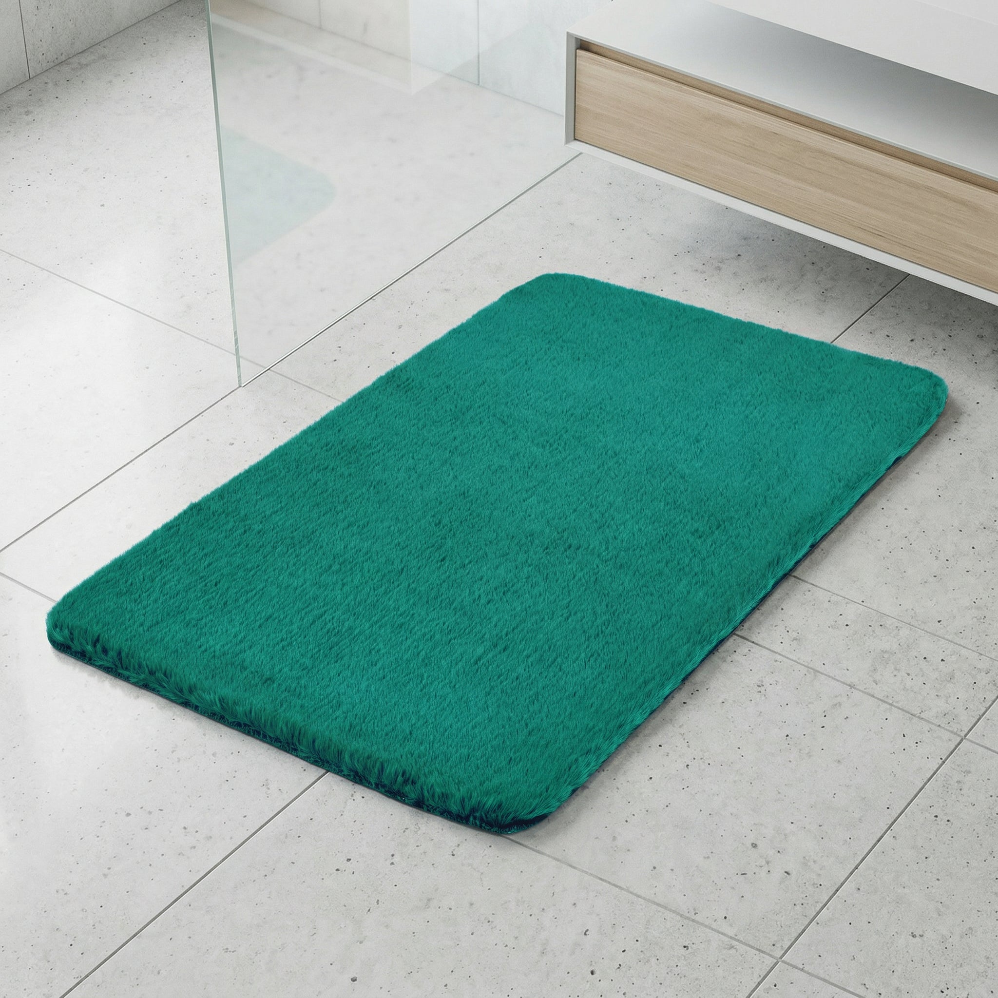 Rechteckige petrolfarbene Badematte auf hellgrauen Fliesenboden aus Stoff