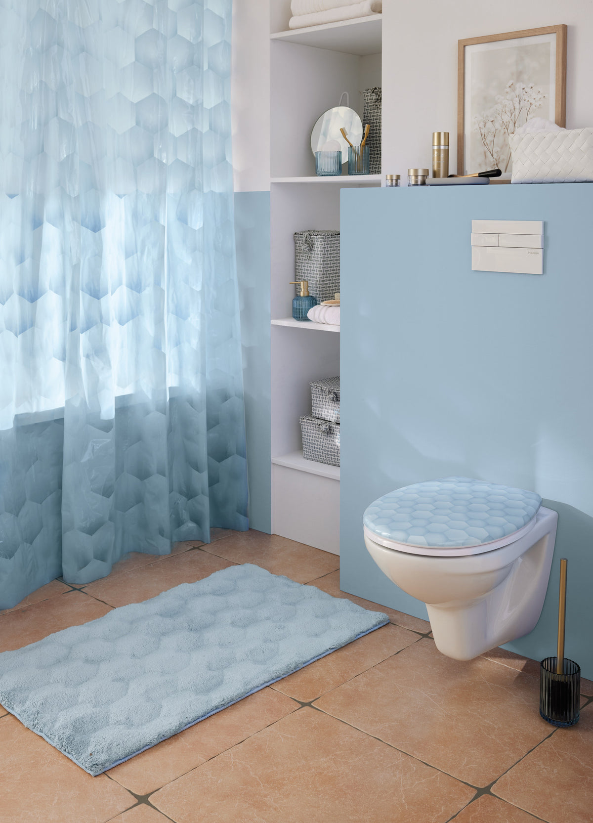 Helles Bad mit blauem Duschvorhang, WC-Sitz und flauschigem Badteppich.