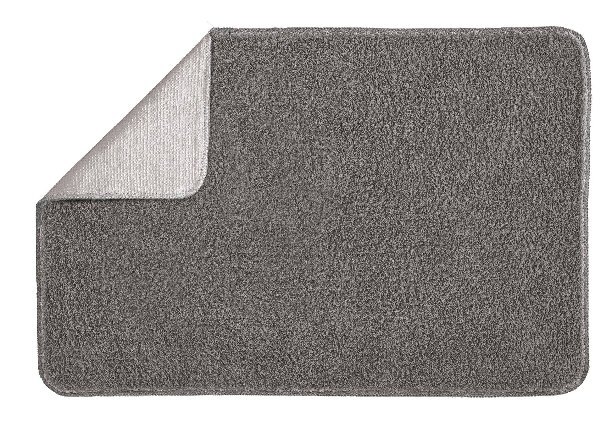 Badteppich MARCO in Anthrazit 60 x 90 cm liegt rechteckig mit umgeklappter Ecke auf hellem Hintergrund.