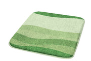 Badteppich MIAMI Minze 50 x 60 cm liegt mit grün gestreiftem Flor auf hellem Untergrund.