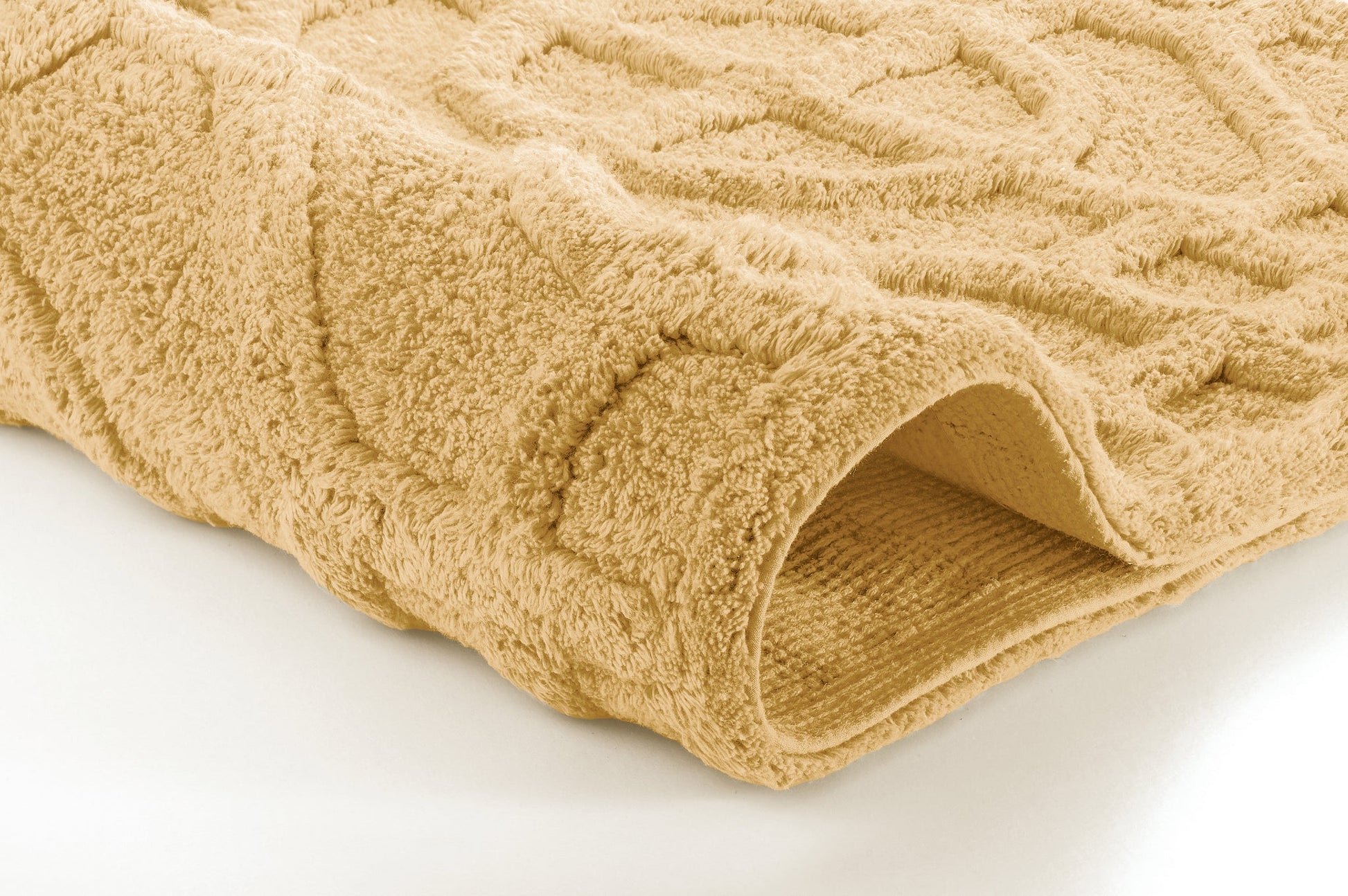 Beiger Badteppich mit Strukturmuster in Nahaufnahme und umgeschlagener Kante