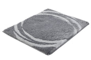 Badteppich MYSTIC Anthrazit 55 x 65 cm liegt flach mit rundem Muster auf weißem Hintergrund.