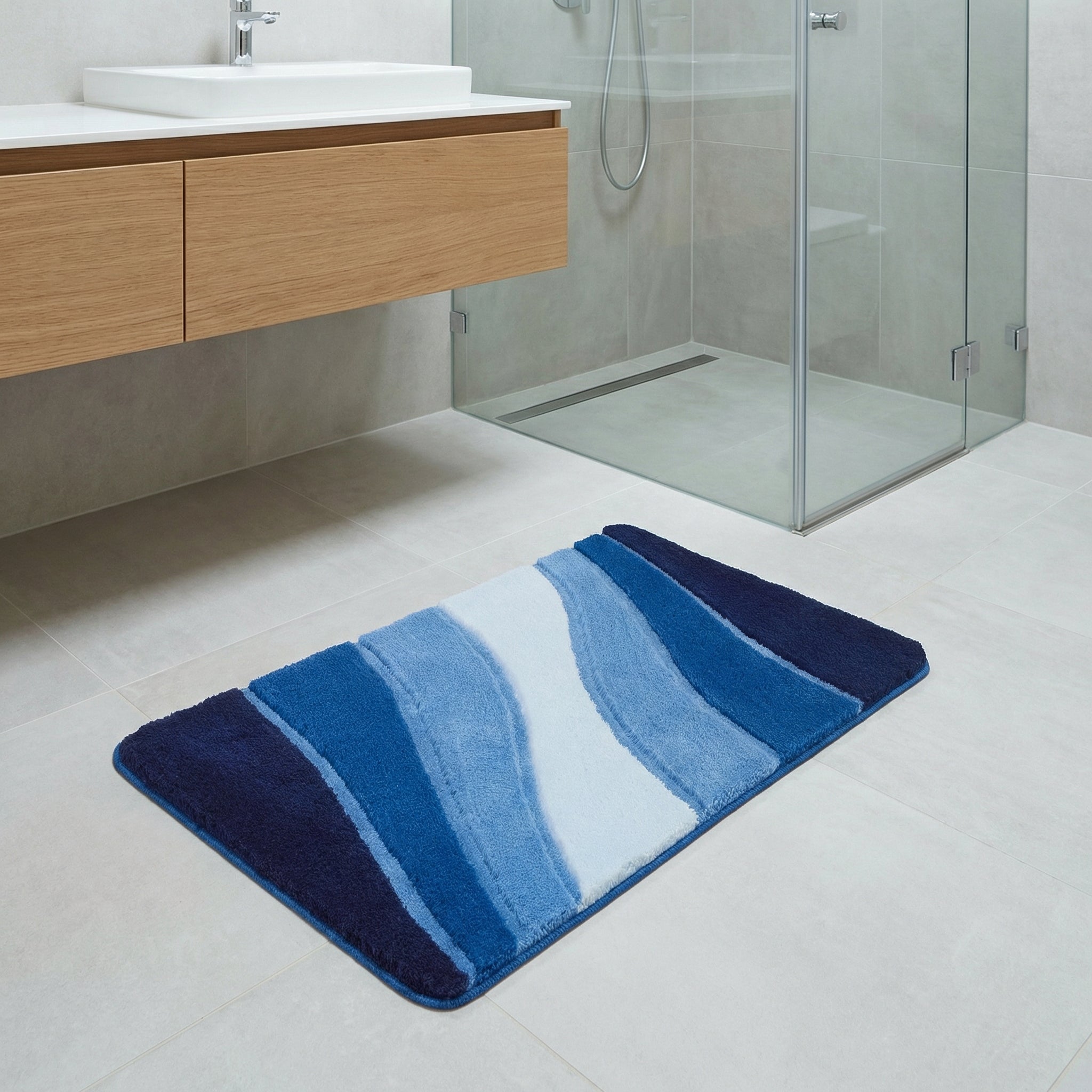 Blau gestreifte Badematte vor Glasdusche in modernem Bad mit Waschbecken