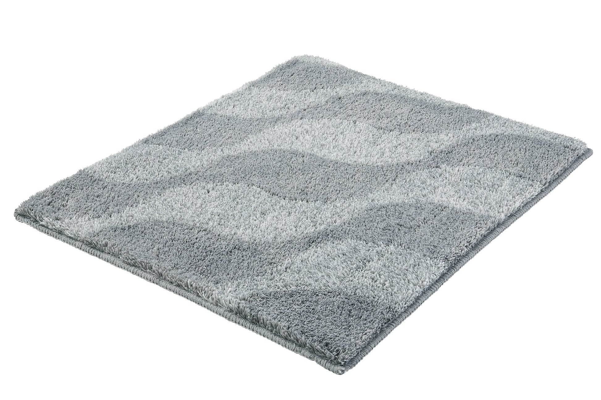 Badteppich ONDA Anthrazit 55 x 65 cm liegt flach mit welligem Muster auf weißem Hintergrund.