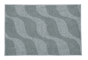 Badteppich ONDA Anthrazit 70 x 120 cm liegt flach mit welligem Muster auf hellem Untergrund.