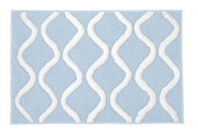 Badteppich PIANA in Stahlblau 60 x 90 cm mit weißen Wellenlinien liegt flach auf hellem Untergrund.