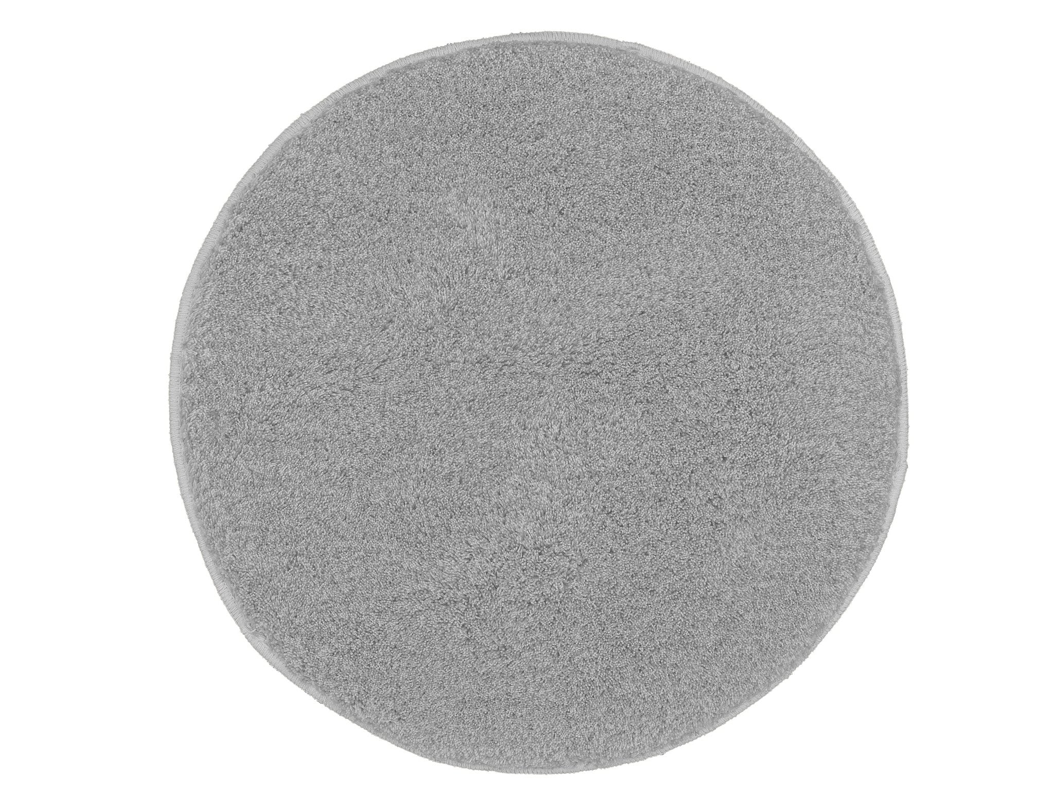 Runder grauer Badteppich RELAX mit 100 cm Durchmesser liegt flach auf hellem Untergrund.