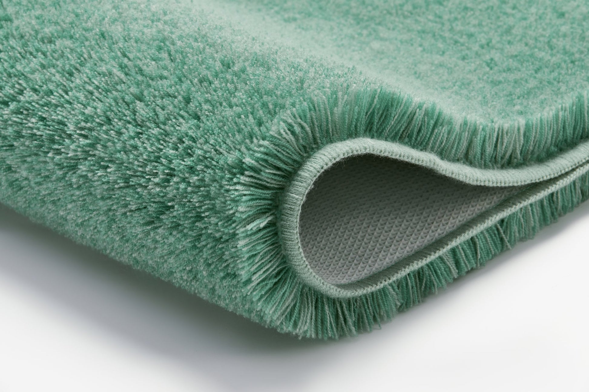 Nahaufnahme Badteppich RELAX Maledivia 60 x 100 cm in Grün mit sichtbarer Rückseite.