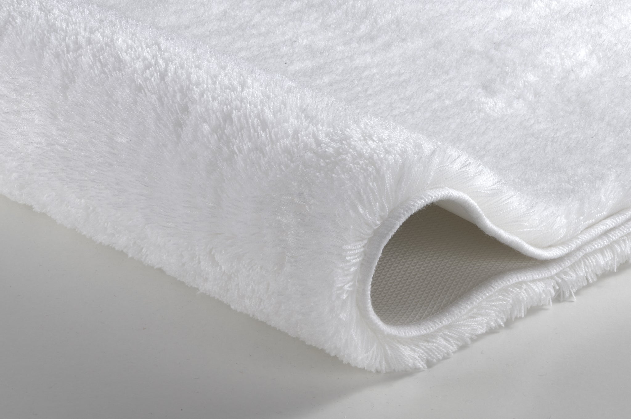 Nahaufnahme des Badteppichs RELAX in Polarweiß mit weicher, dichter Oberfläche und rutschhemmender Unterseite.