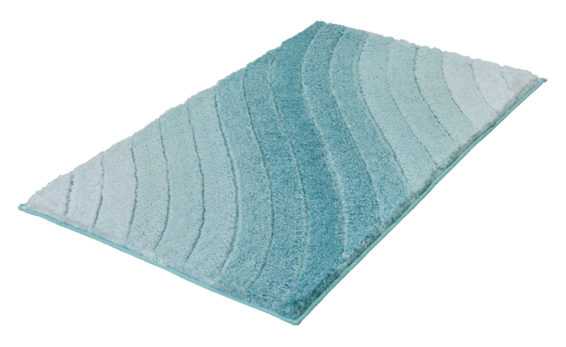 Türkisfarbener Badematte mit Wellenmuster auf weißem Hintergrund liegend