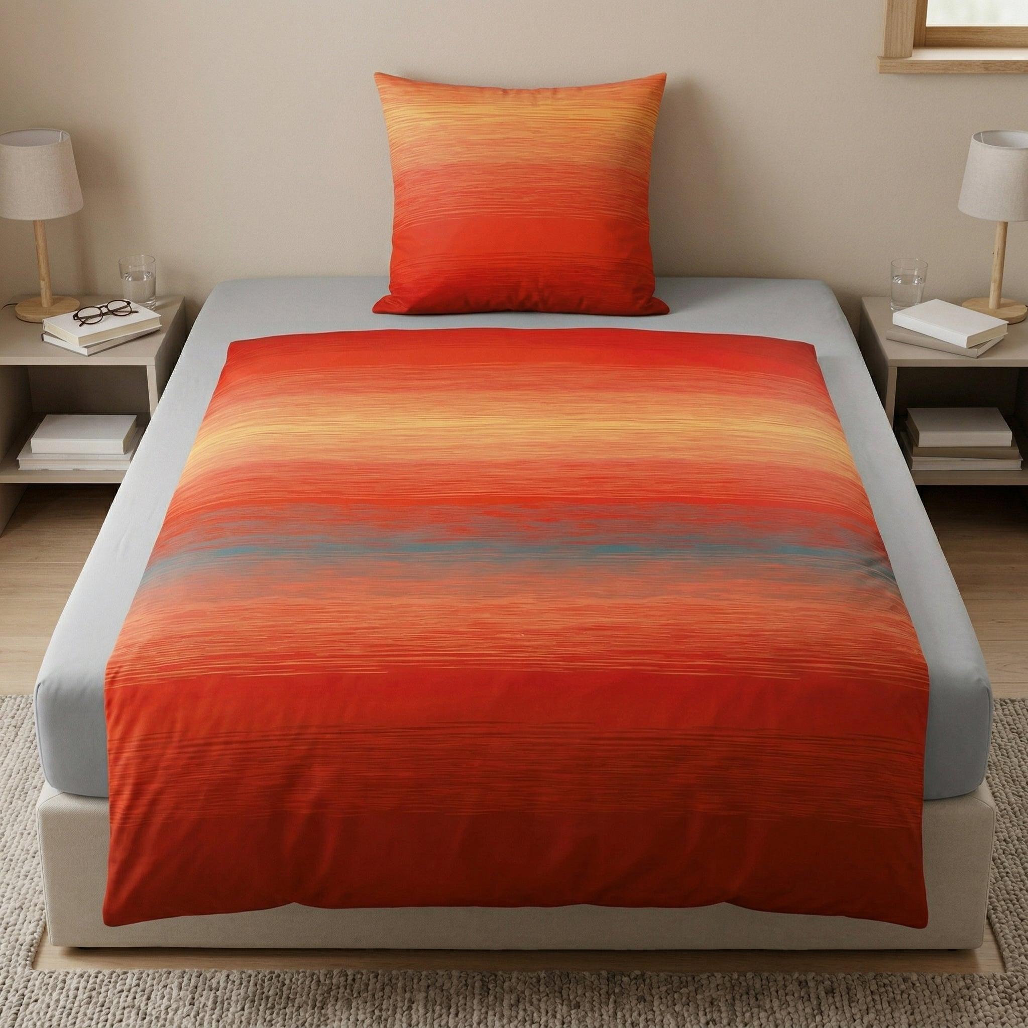 Bettwäsche in Rot-Orange-Verlauf auf Bett im hellen Schlafzimmer.