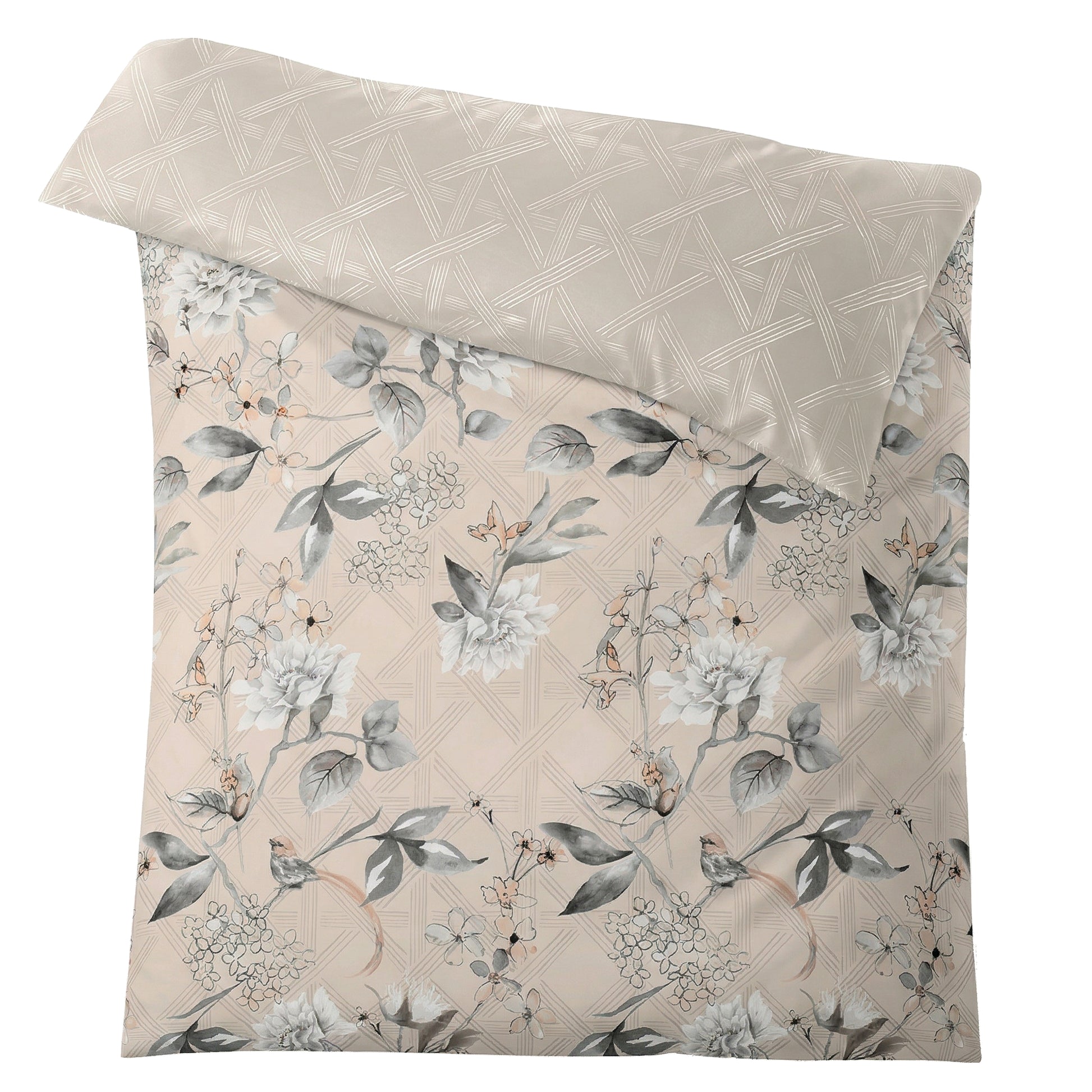 Beige Bettwäsche mit grauem Blumenmuster und grafischer Rückseite.