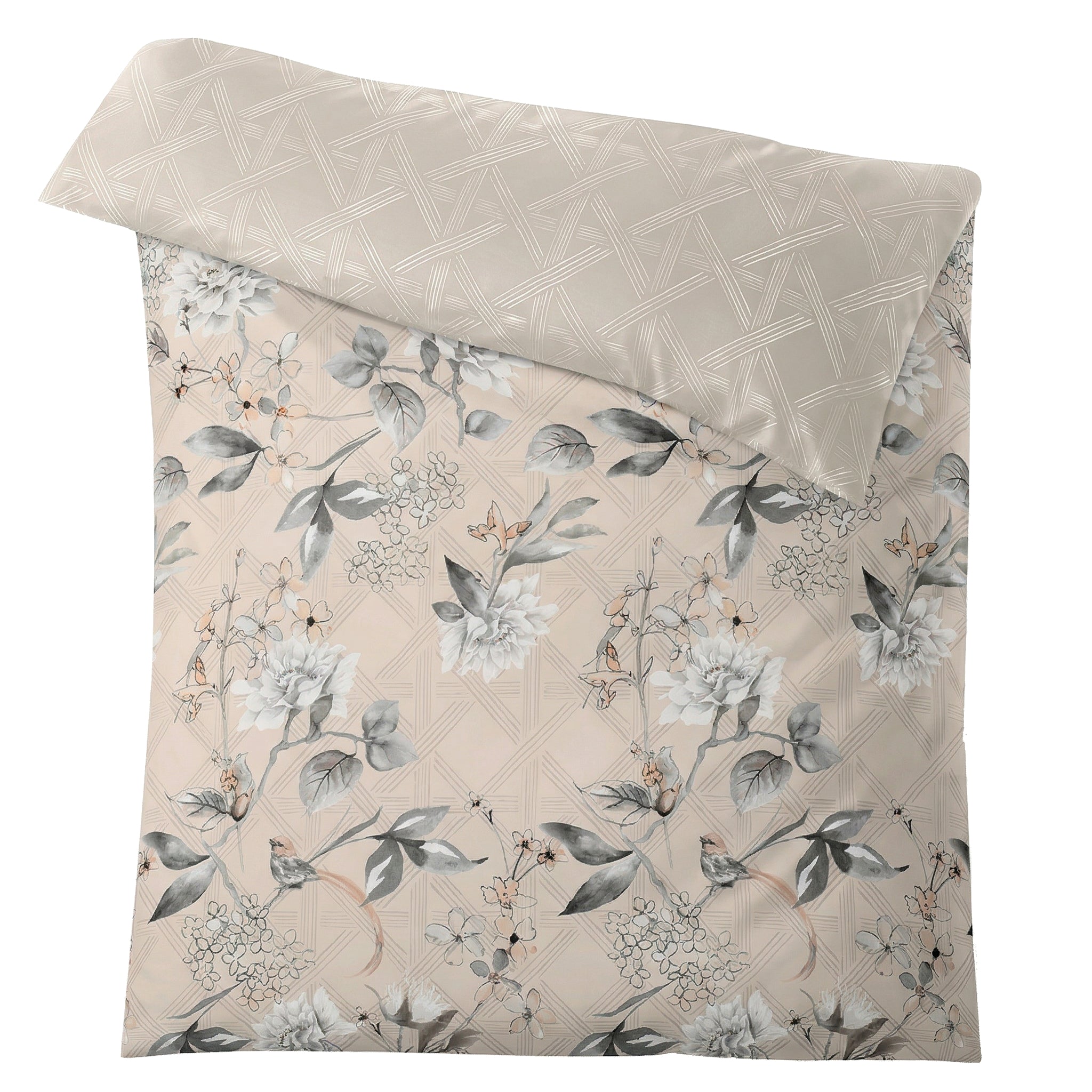 Beige Bettwäsche mit grauem Blumenmuster und grafischer Rückseite.