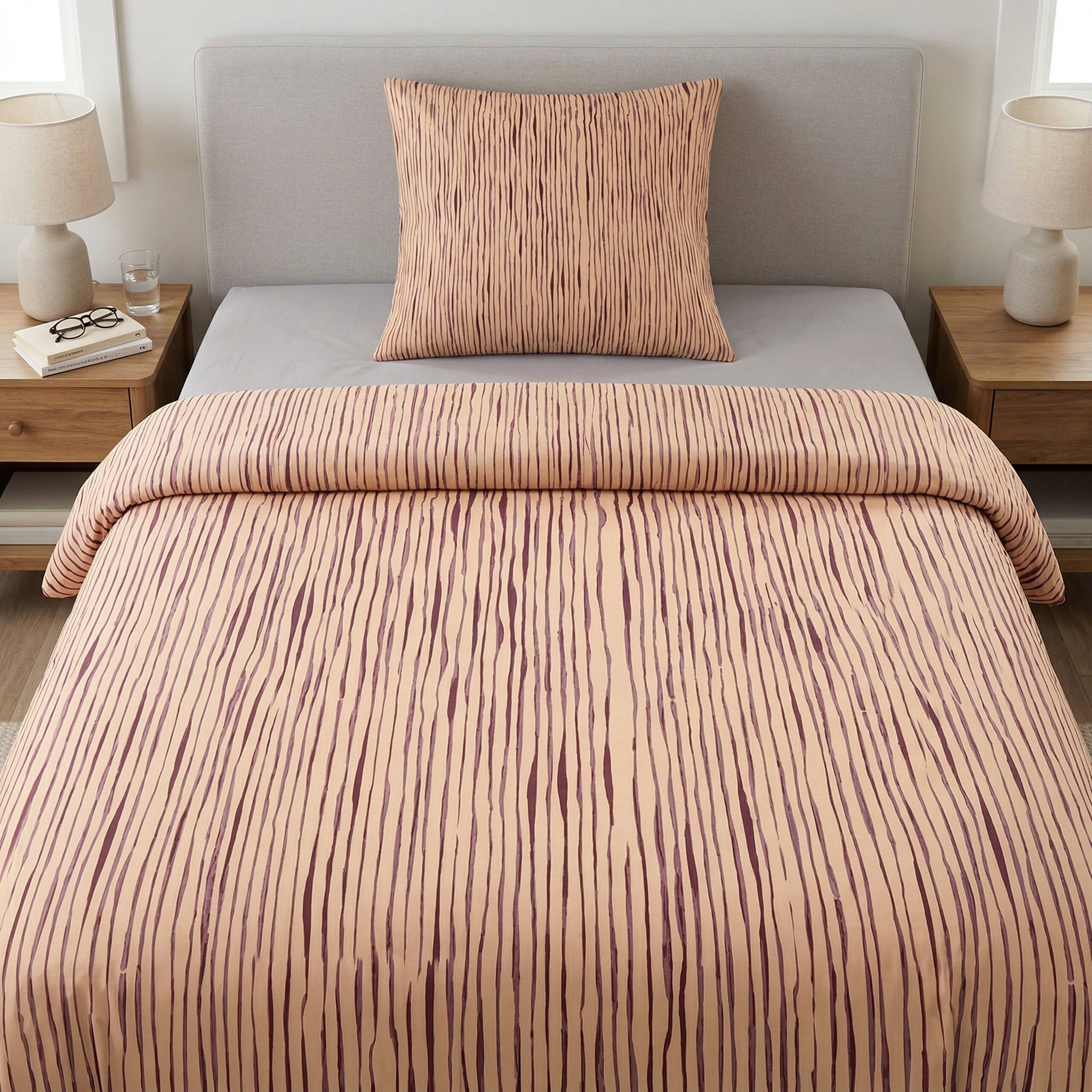 Gestreifte Bettwäsche in Beige-Lila auf Bett im hellen Schlafzimmer.
