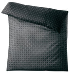 Grau-grüne Bettwäsche mit grafischem Kreismuster.