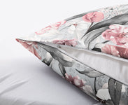 Floraler Kissenbezug mit Reißverschluss auf weichem, hellem Bettlaken