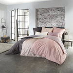 Doppelbett mit roséfarbener Satin-Bettwäsche in modernem Schlafzimmer