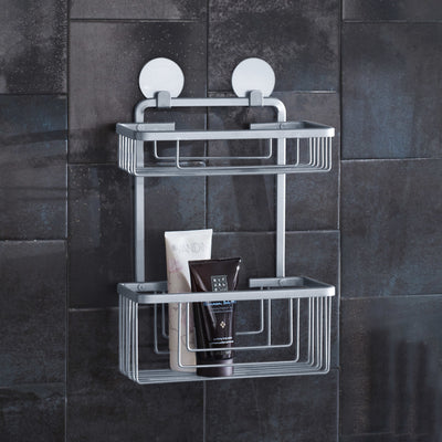 Zweistöckiger Kleine Wolke Bubble Duschkorb mit zwei Saugnäpfen und Duschgel auf dunkler Fliesenwand.