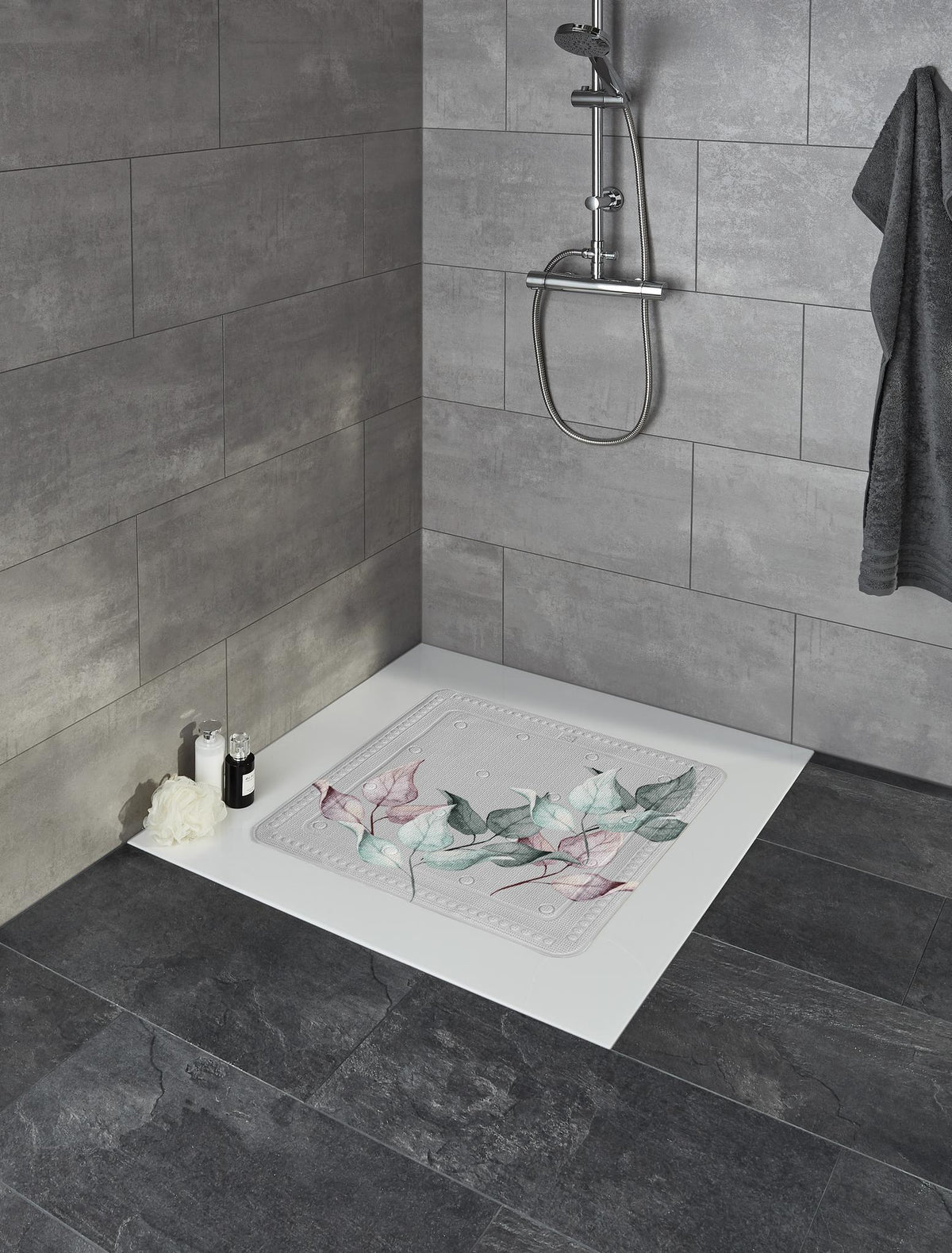  Antirutschmatte mit Blättermotiv auf weißer Dusche in modernem grauen Bad.
