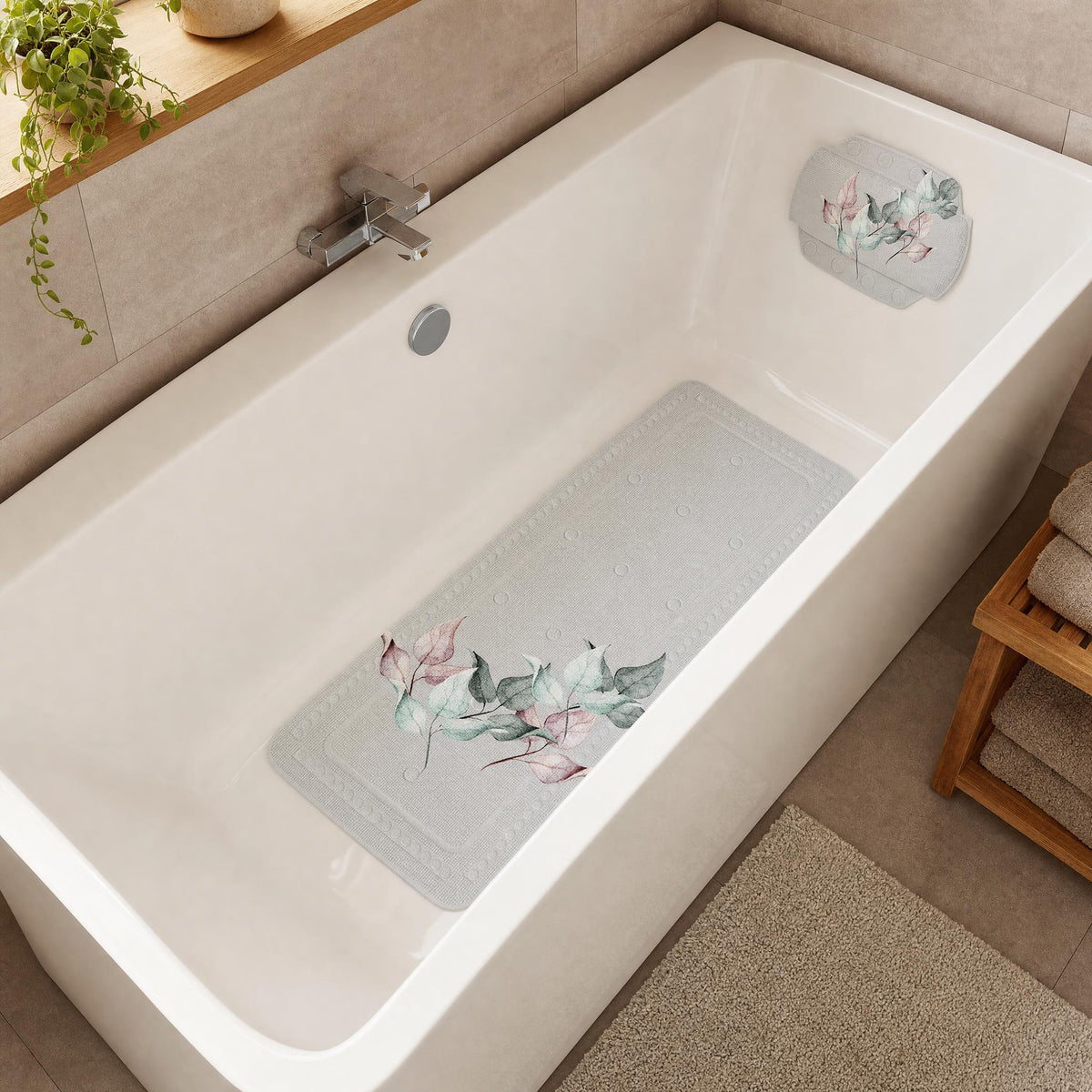 Weiße Badewanne mit floralem Wannenkissen und passender Antirutschmatte.