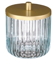 Geriffelte Glasdose mit goldfarbenem Deckel vor weißem Hintergrund.
